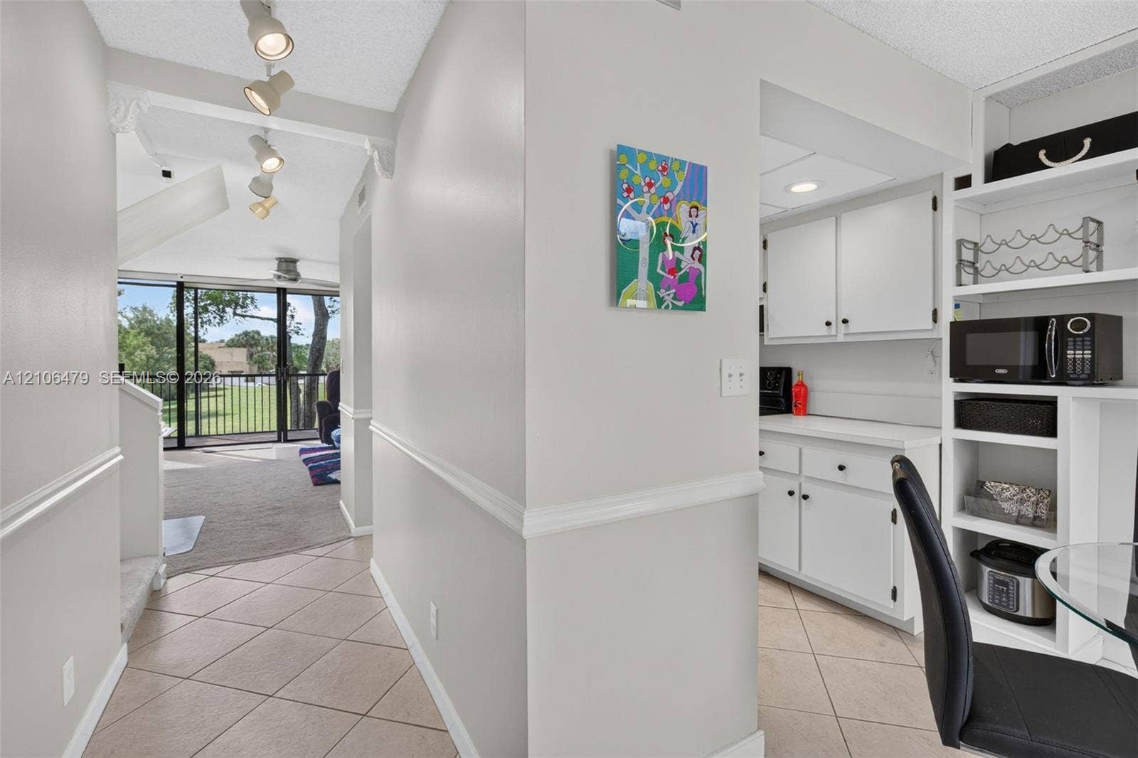 2800 SW 87th Avenue, #1113, Davie, FL 33328 Tile flooring, track lighting, built-in cabinetry, and white shaker-style lower cabinets with a coordinating countertop