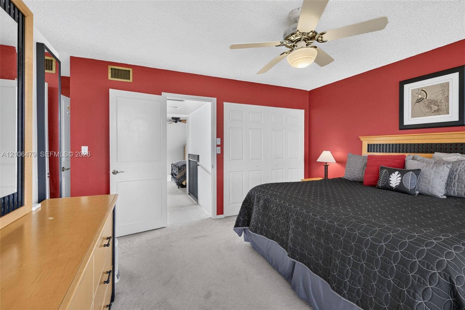 2800 SW 87th Avenue, #1113, Davie, FL 33328 Room featuring neutral carpeting, multi-panel closet doors, and a ceiling fan with integrated lighting