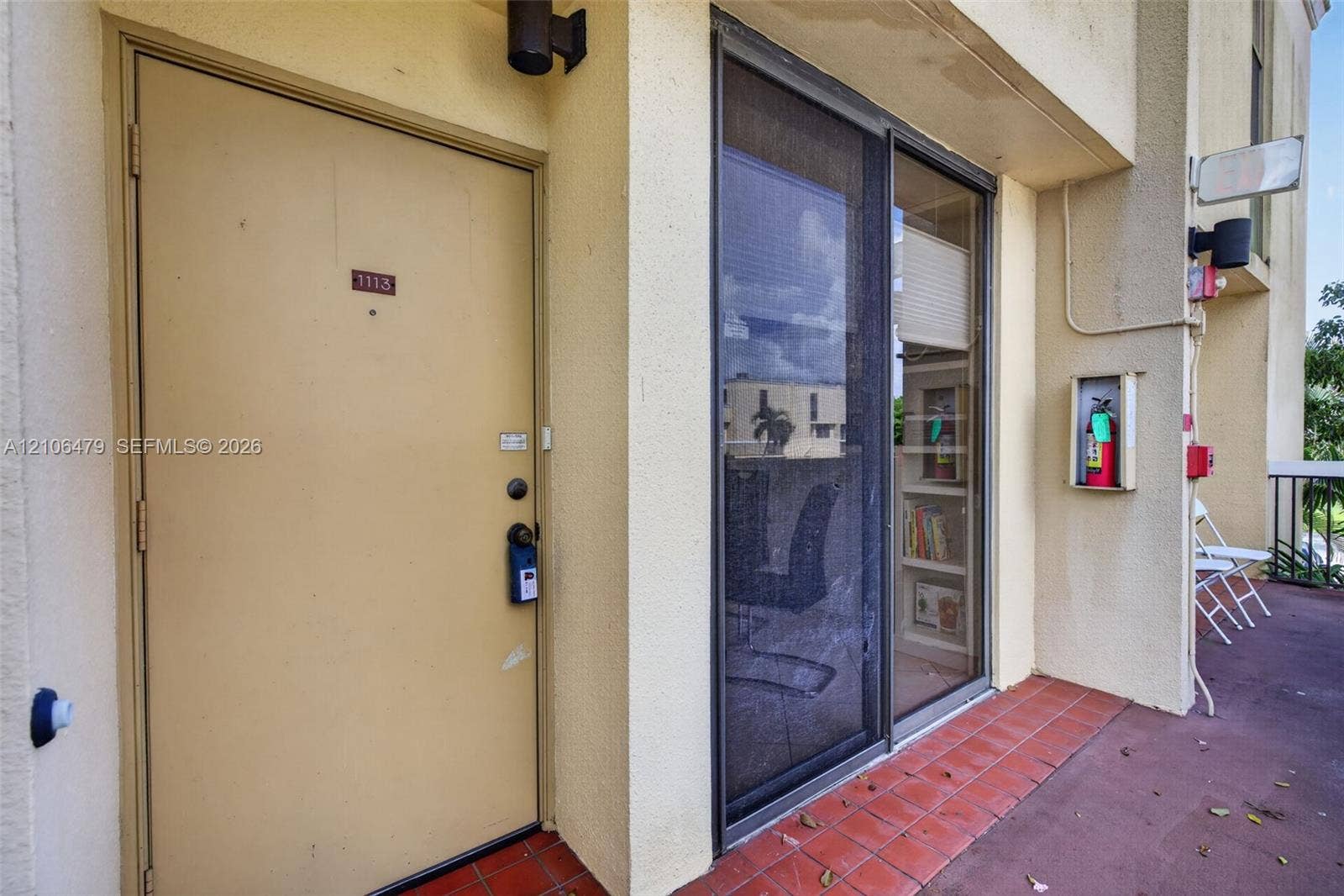 2800 SW 87th Avenue, #1113, Davie, FL 33328 Exterior entryway featuring a solid-core door, sliding glass door with screen, stucco exterior wall finish, and tiled flooring