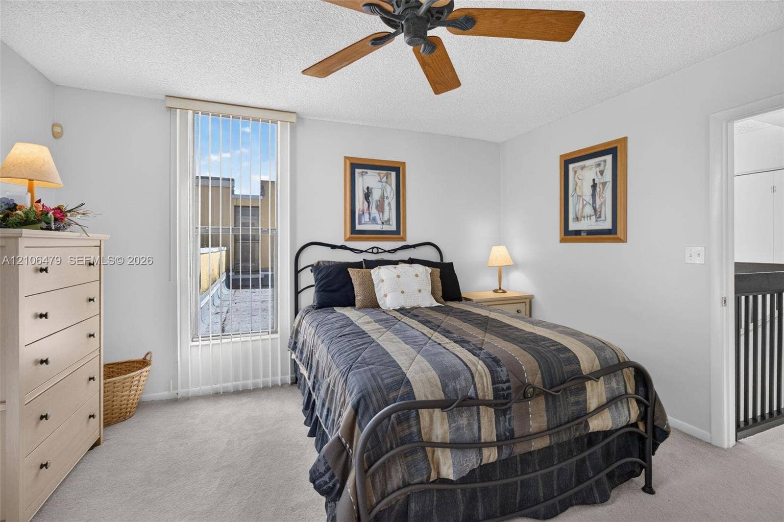 2800 SW 87th Avenue, #1113, Davie, FL 33328 Bedroom featuring a tall vertical window with vertical blinds, carpeted flooring, and a ceiling fan with light fixture