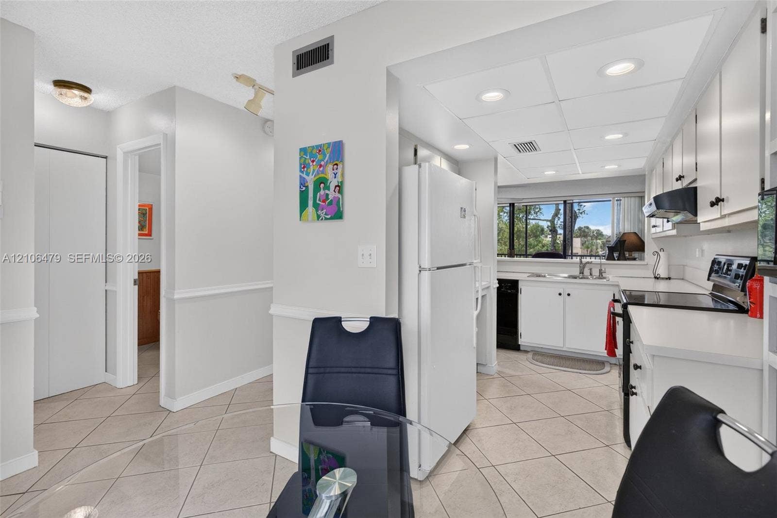 2800 SW 87th Avenue, #1113, Davie, FL 33328 Kitchen featuring white cabinetry, integrated appliances, recessed lighting, and tile flooring