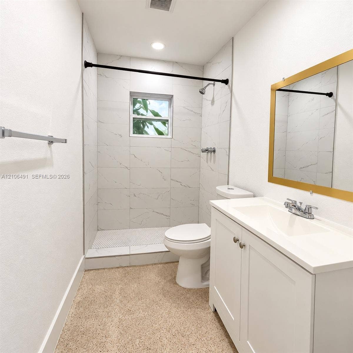 Bathroom featuring large-format veined tile shower surround, shower pan with geometric tile floor, white vanity with integrated sink, and recessed ceiling lighting