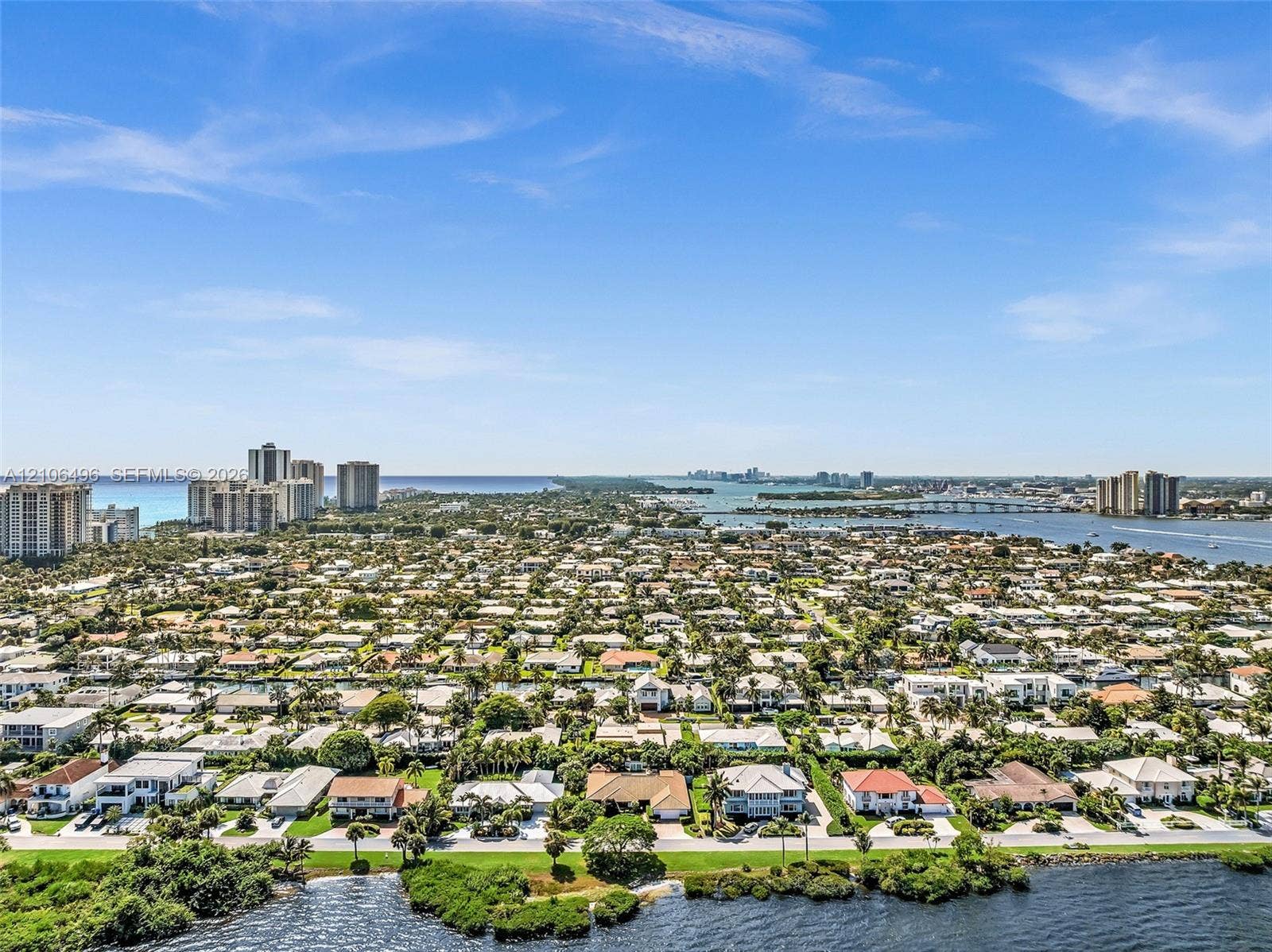 Aerial perspective of the coastal landscape featuring a deep-water inlet, shoreline vegetation, and proximity to the ocean horizon