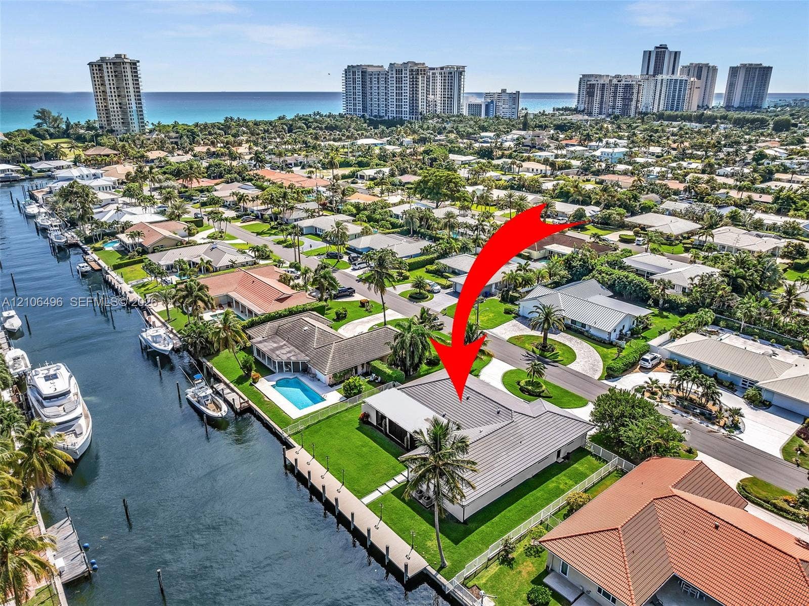 Waterfront property featuring a private boat dock, rectangular swimming pool, and concrete-tile roofing