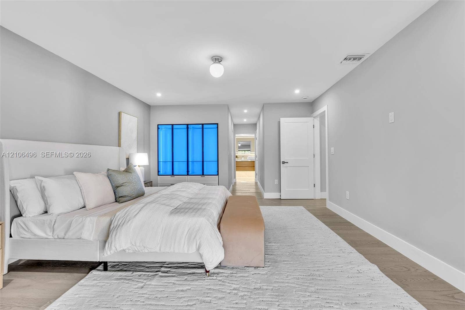 Neutral interior space featuring wood-finish flooring, recessed lighting, and a globe-style ceiling fixture
