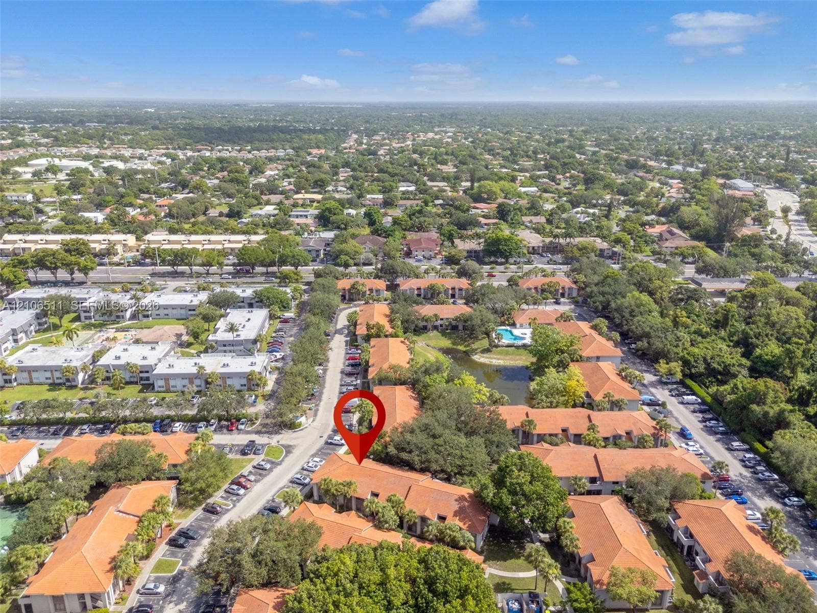 3229 Coral Lake Drive, #3229, Coral Springs, FL 33065 Aerial view of residential community featuring terra-cotta tile rooflines, mature canopy trees, and an established landscaping layout