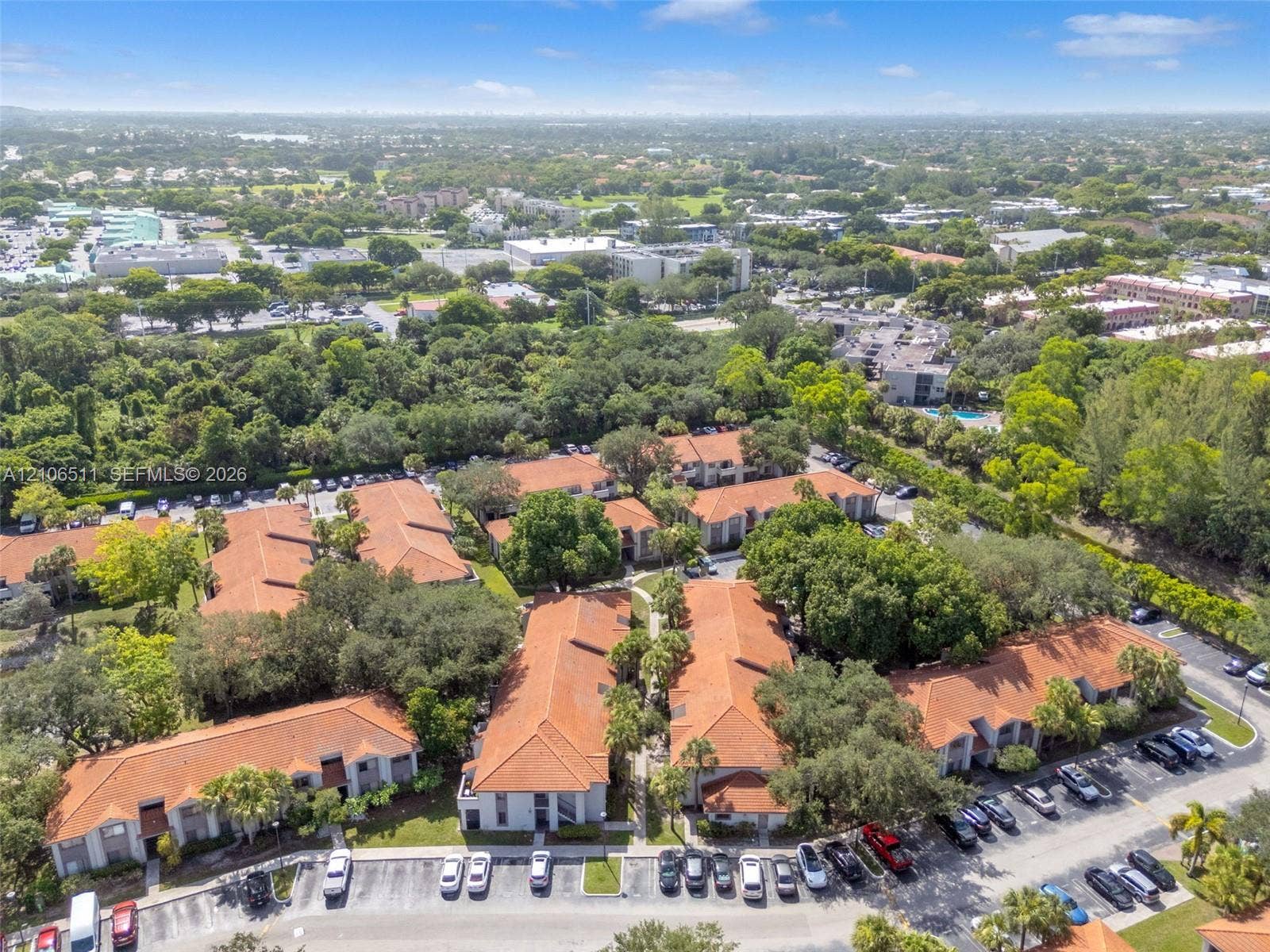 3229 Coral Lake Drive, #3229, Coral Springs, FL 33065 Aerial perspective of a multi-unit complex featuring clay tile roof systems, stucco-finish exteriors, and established perimeter landscaping