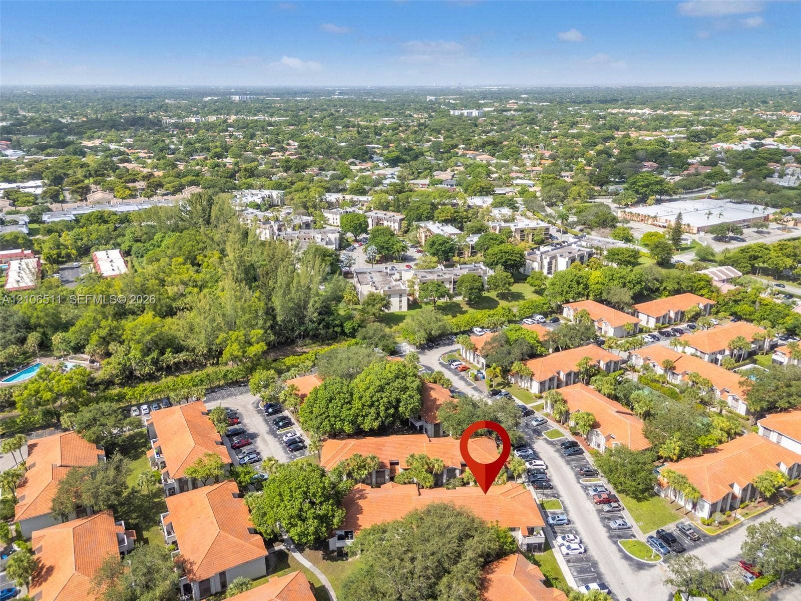 3229 Coral Lake Drive, #3229, Coral Springs, FL 33065 Aerial perspective of a residential complex featuring tile roofing and lush landscaping within a tree-lined community
