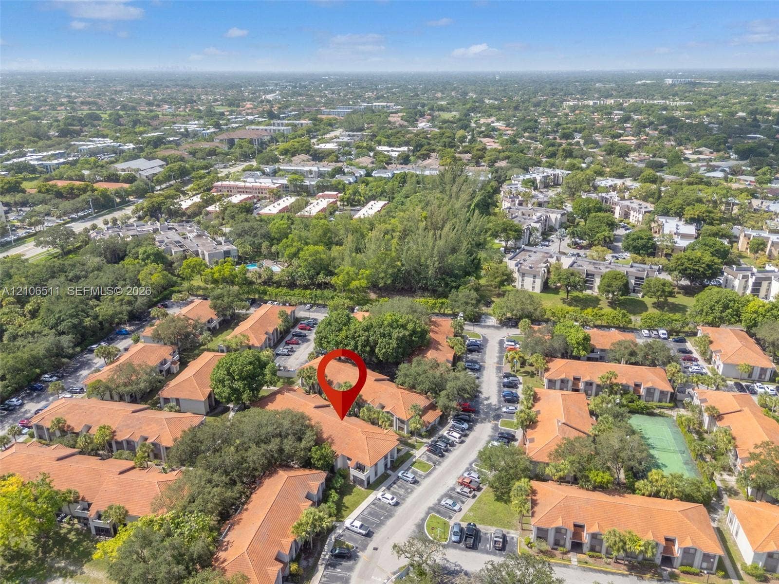 3229 Coral Lake Drive, #3229, Coral Springs, FL 33065 Aerial perspective of a multi-unit residential complex featuring terracotta-tiled roofs, paved surface parking, and mature perimeter landscaping