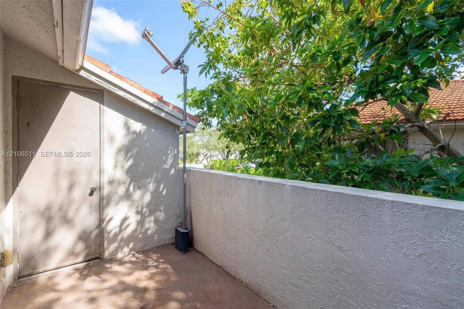 3229 Coral Lake Drive, #3229, Coral Springs, FL 33065 Private balcony featuring a stucco wall enclosure, concrete flooring, and a dedicated storage closet