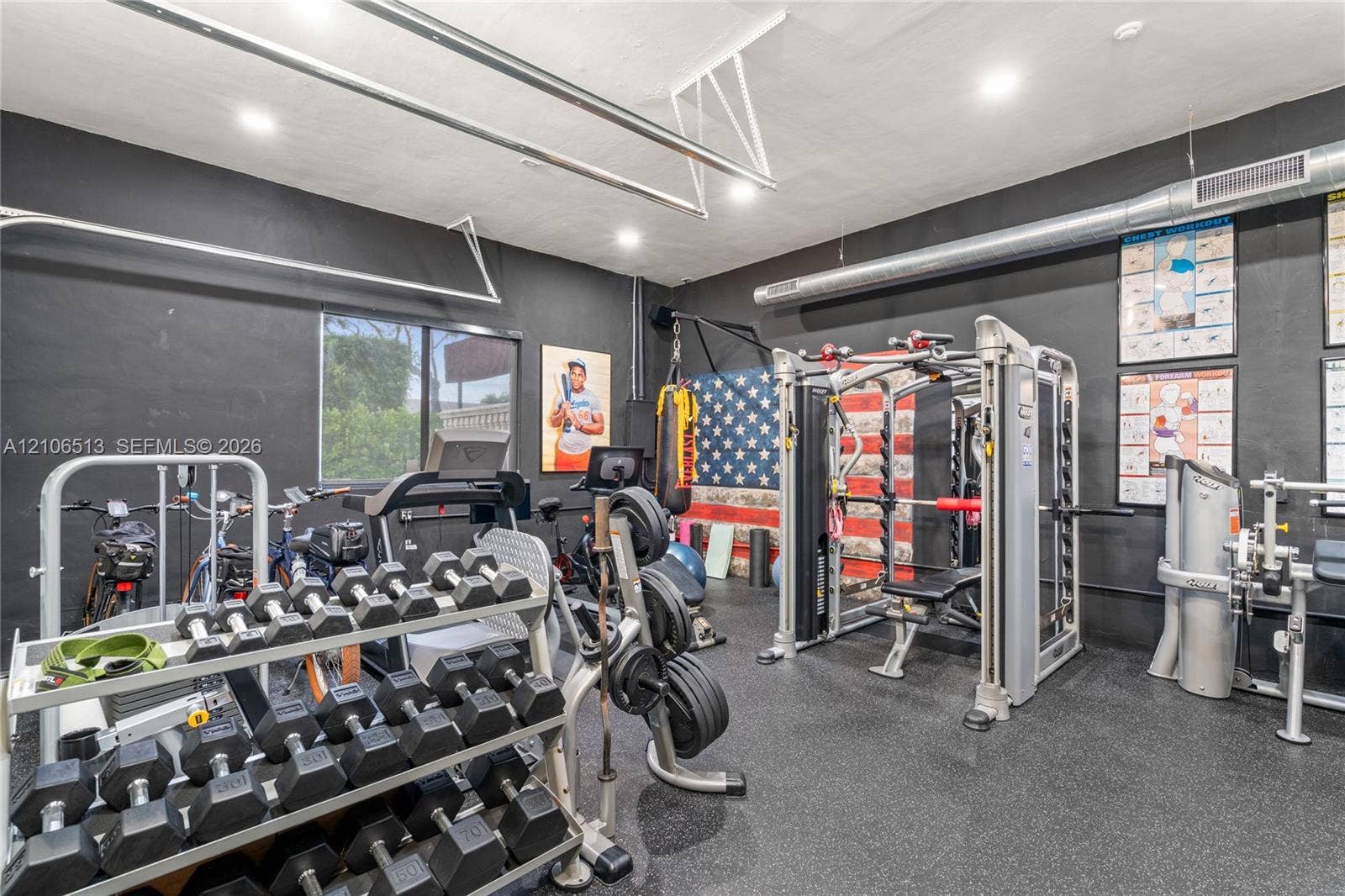 5720 SW 128th Street, Pinecrest, FL 33156 Finished garage space featuring matte black wall paint, rubberized flooring, exposed metal ductwork, and recessed lighting
