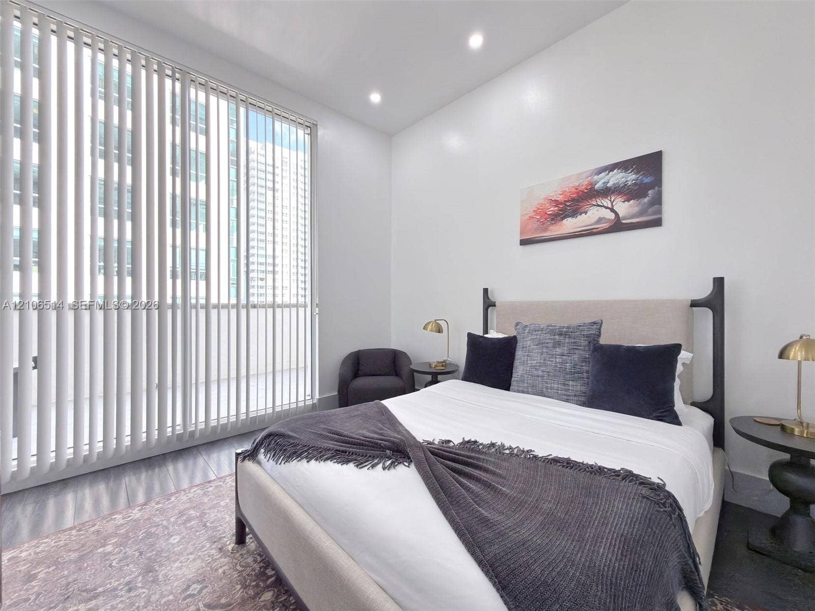 Floor-to-ceiling vertical blinds, recessed lighting, and dark-toned flooring