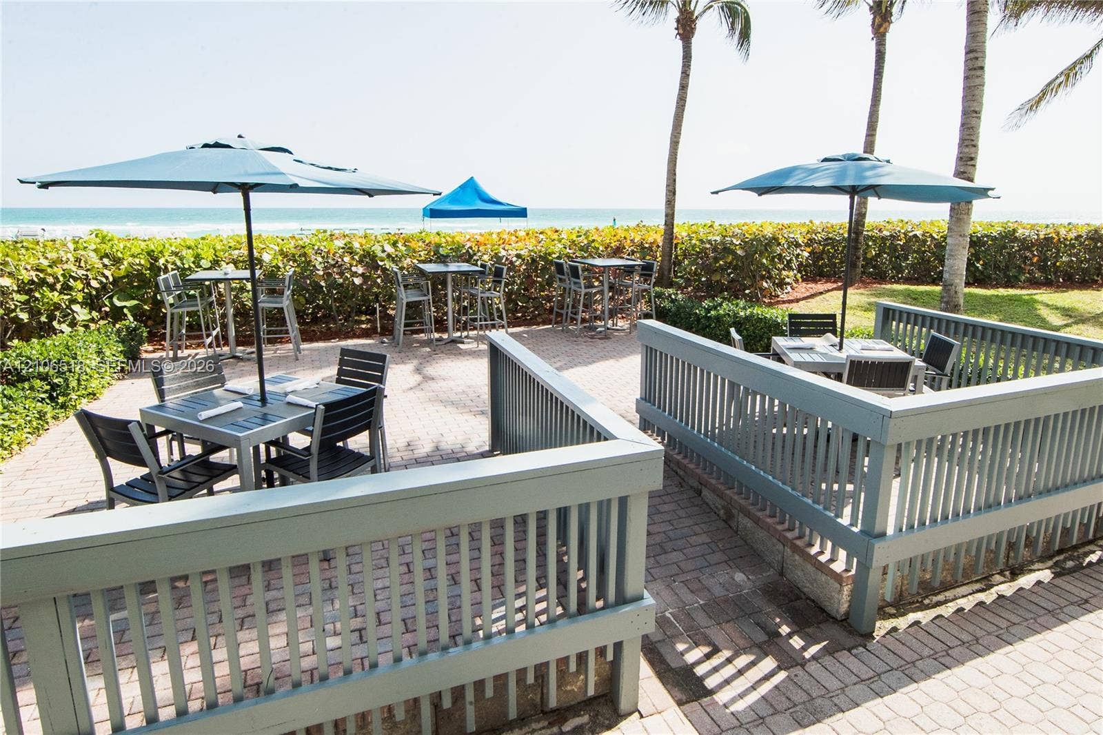 16500 Collins Avenue, #554, Sunny Isles Beach, FL 33160 Paver patio featuring perimeter railings and mature palms with ocean frontage