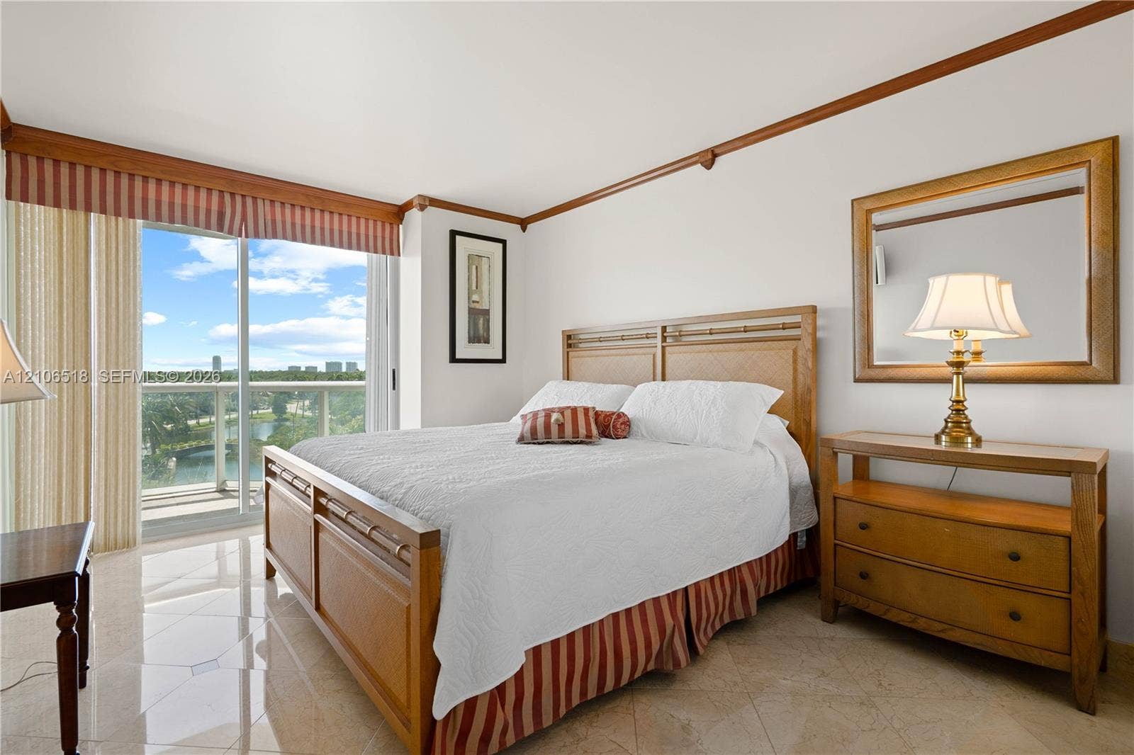 16500 Collins Avenue, #554, Sunny Isles Beach, FL 33160 Polished stone flooring, crown molding, and sliding glass doors with balcony access