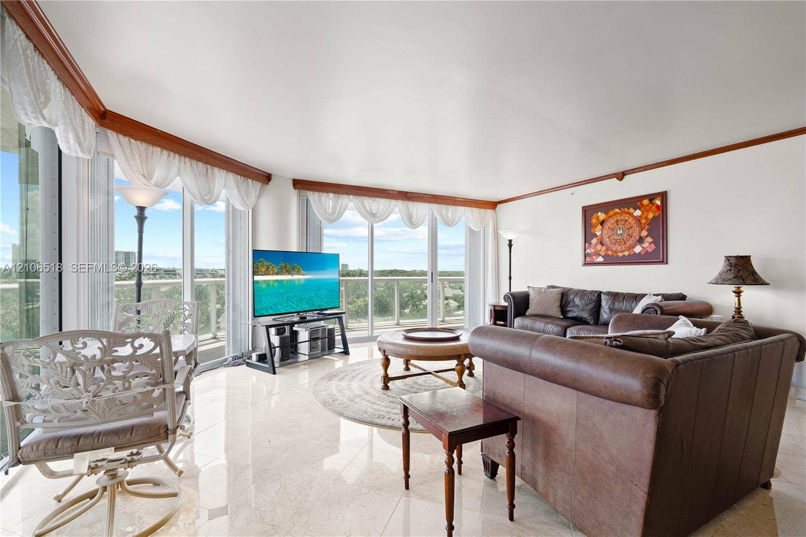 16500 Collins Avenue, #554, Sunny Isles Beach, FL 33160 Living area featuring polished stone tile flooring, floor-to-ceiling glass walls, and crown molding
