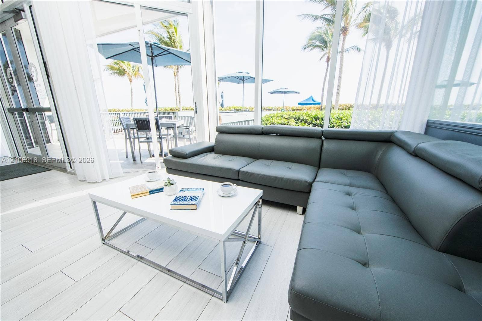 16500 Collins Avenue, #554, Sunny Isles Beach, FL 33160 Enclosed patio featuring floor-to-ceiling glass paneling, light-toned tile flooring, and access to an exterior terrace