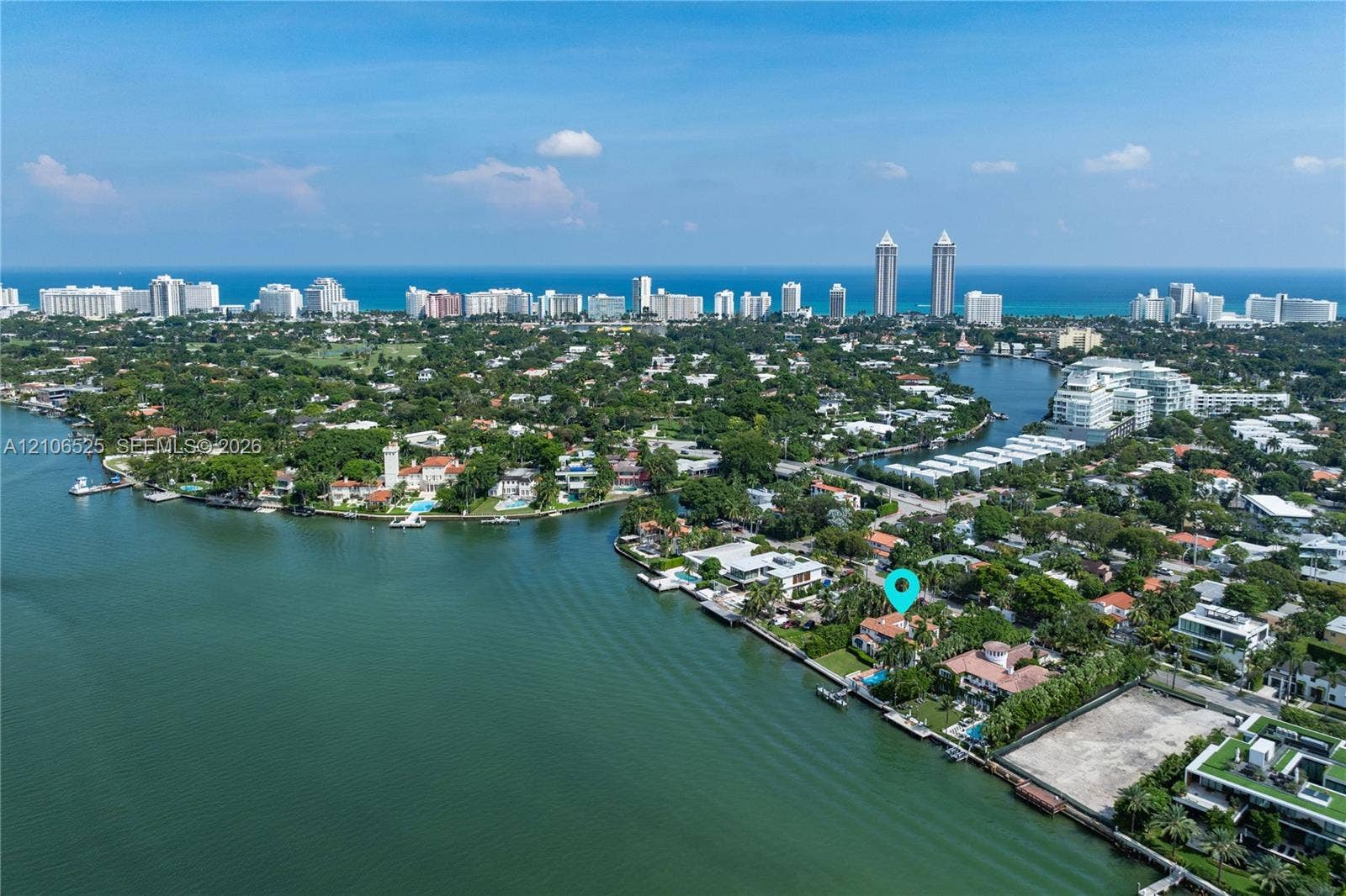 4760 N Bay Road, Miami Beach, FL 33140 Waterfront property featuring direct maritime access, a private dock, and an expansive backyard situated along a deep-water canal