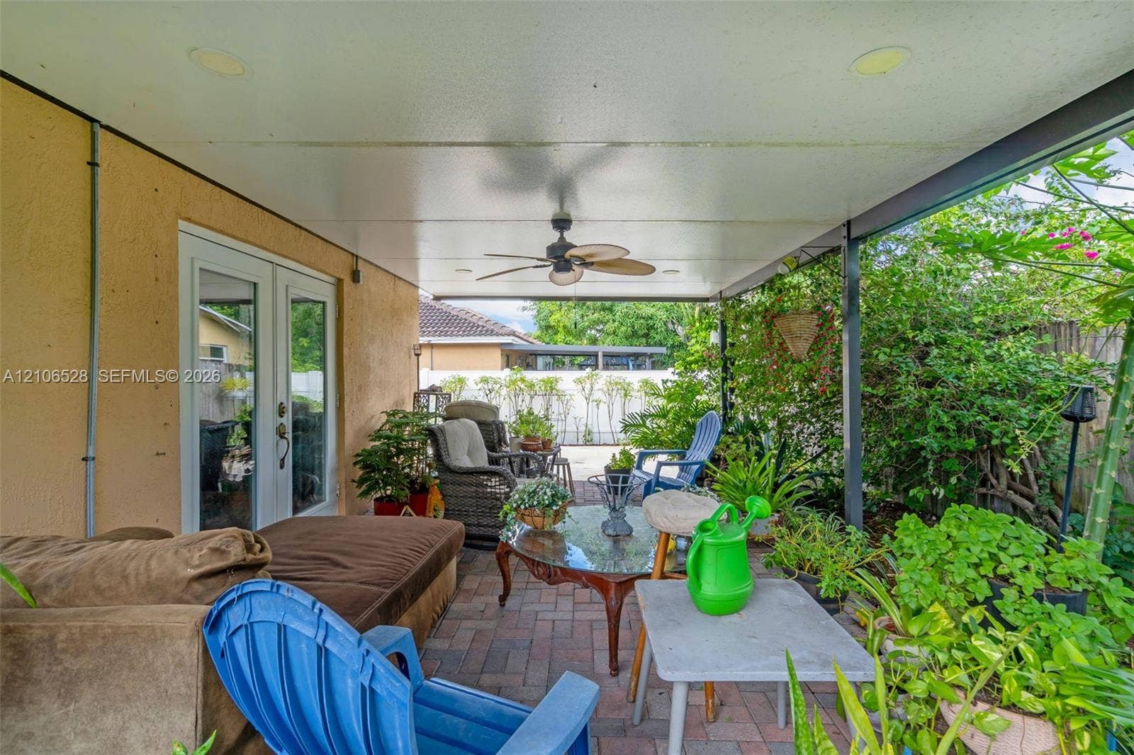 2615 NW 14th Street, Fort Lauderdale, FL 33311 Covered patio featuring a paved brick floor, recessed ceiling lighting, a ceiling fan, and French glass entry doors