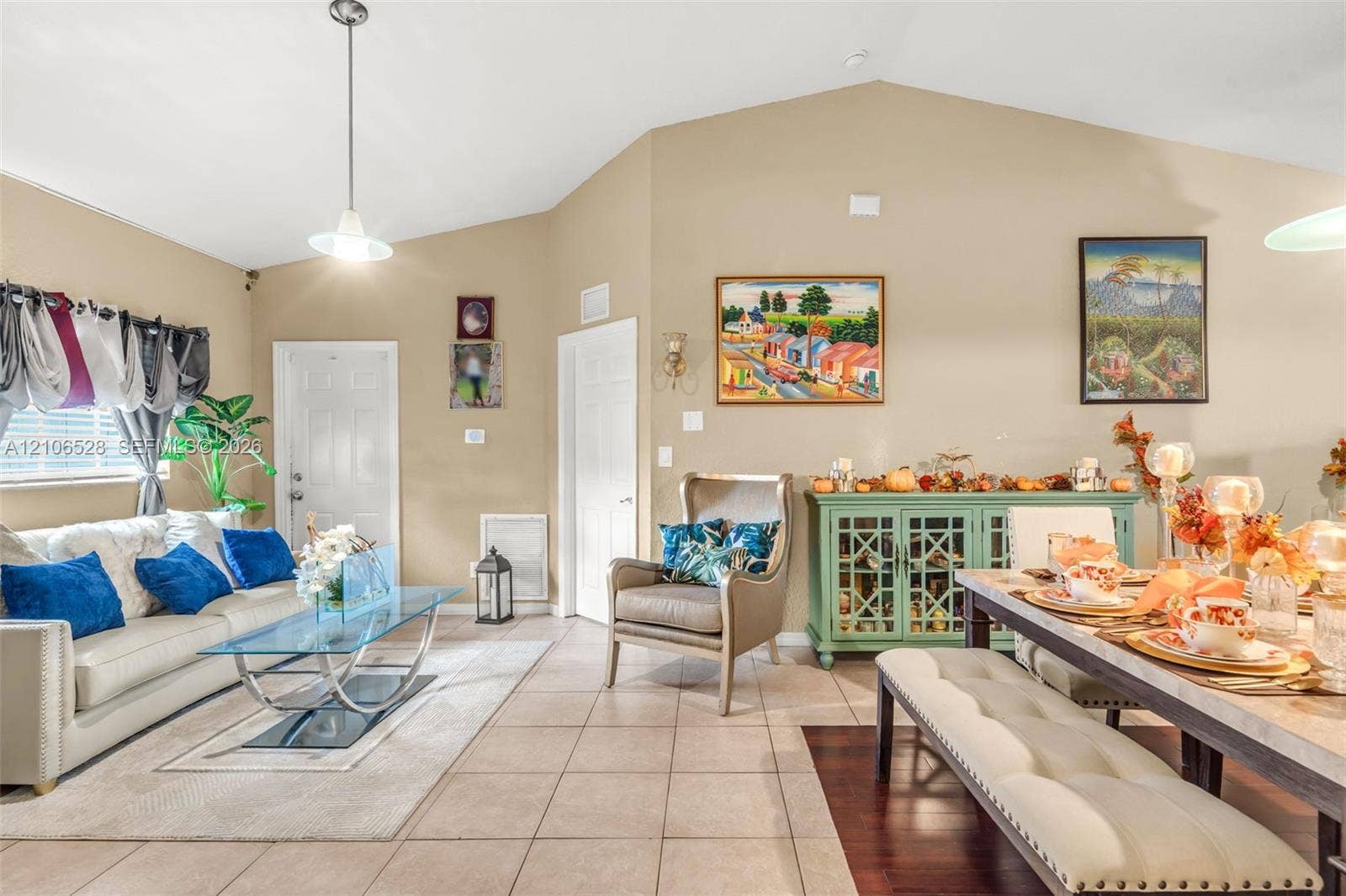 2615 NW 14th Street, Fort Lauderdale, FL 33311 Vaulted ceilings, neutral wall tones, ceramic tile flooring, and a pendant light fixture
