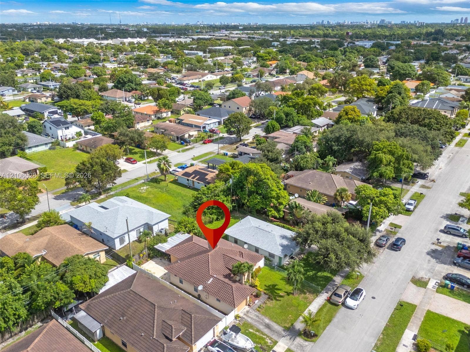 2615 NW 14th Street, Fort Lauderdale, FL 33311 Aerial view of a residential lot featuring a concrete tile roof, attached garage, and paved driveway