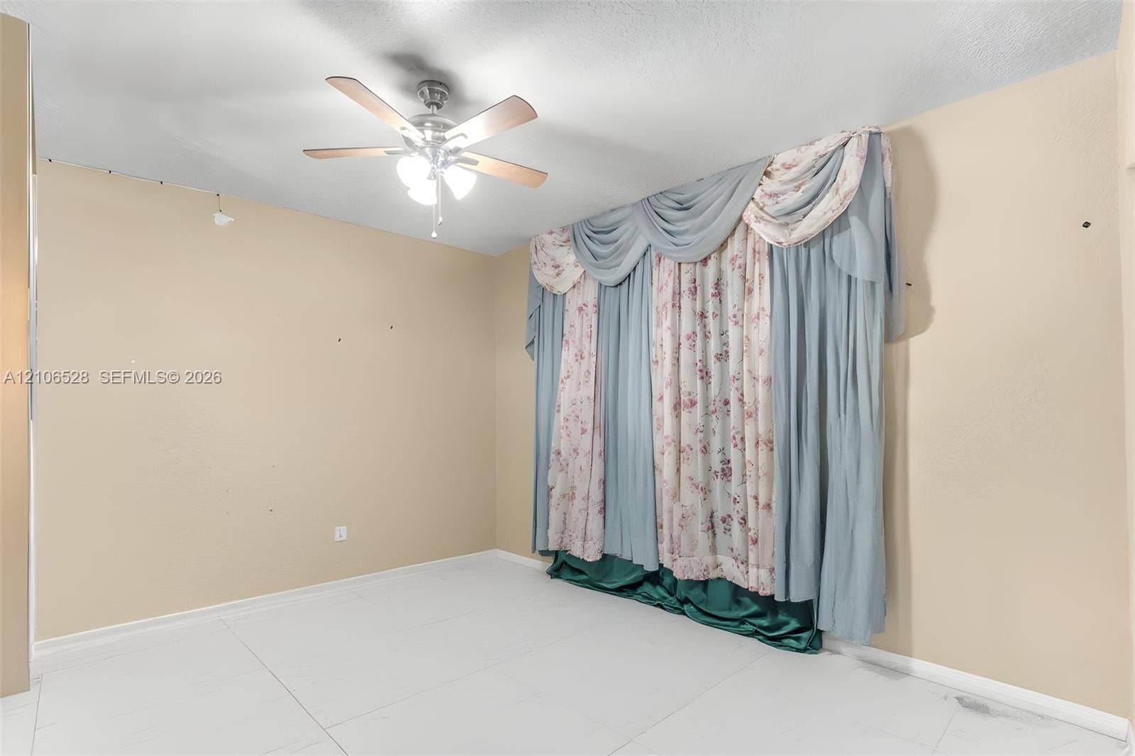 2615 NW 14th Street, Fort Lauderdale, FL 33311 Room featuring white tile flooring and a ceiling-mounted fan with integrated lighting