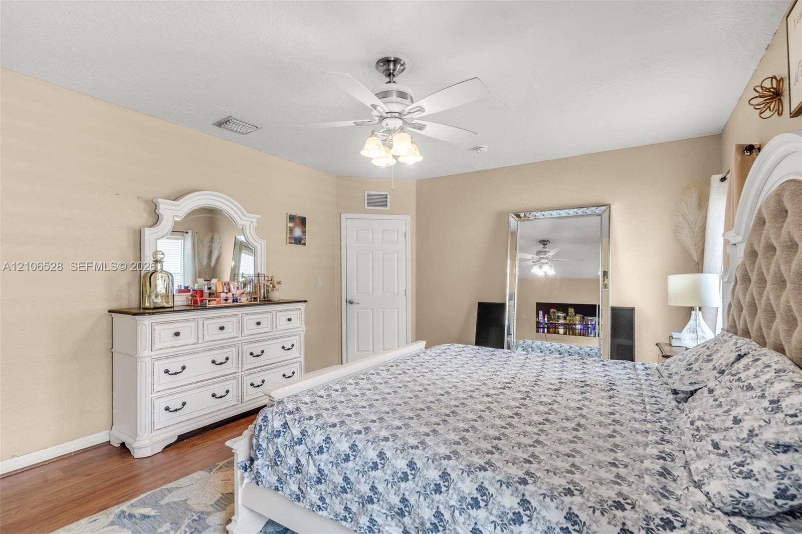 2615 NW 14th Street, Fort Lauderdale, FL 33311 Bedroom featuring wood-finish flooring, a multi-blade ceiling fan with integrated lighting, and a neutral wall finish