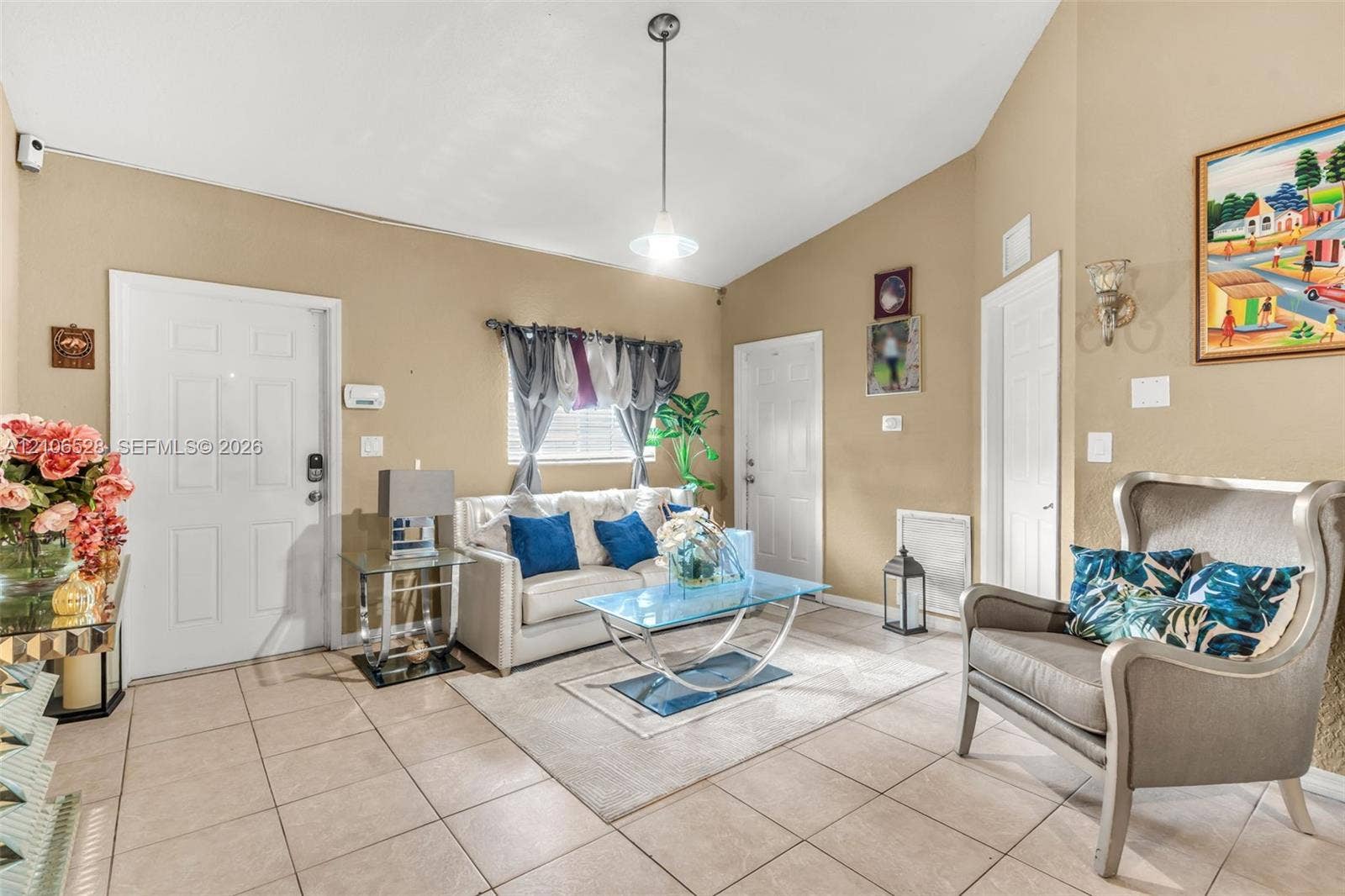 2615 NW 14th Street, Fort Lauderdale, FL 33311 Vaulted ceilings, large-format tile flooring, and a central pendant light fixture