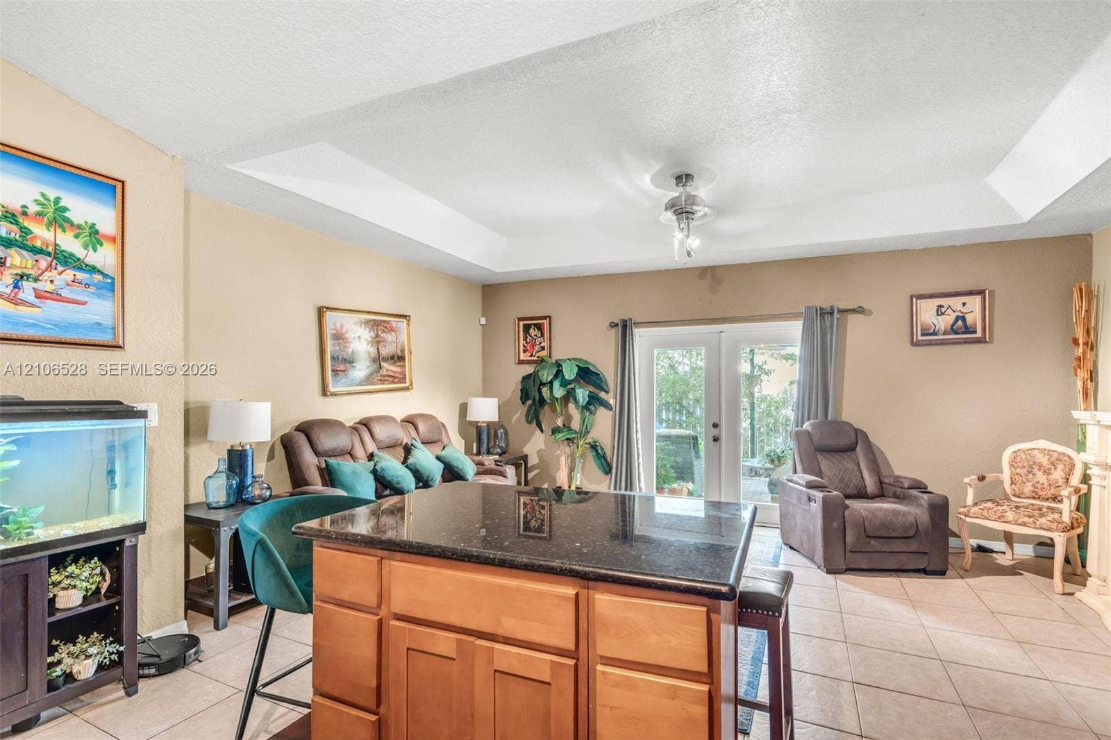 2615 NW 14th Street, Fort Lauderdale, FL 33311 Tray ceiling with recessed lighting, center island with dark stone countertop and wood cabinetry, and double glass doors