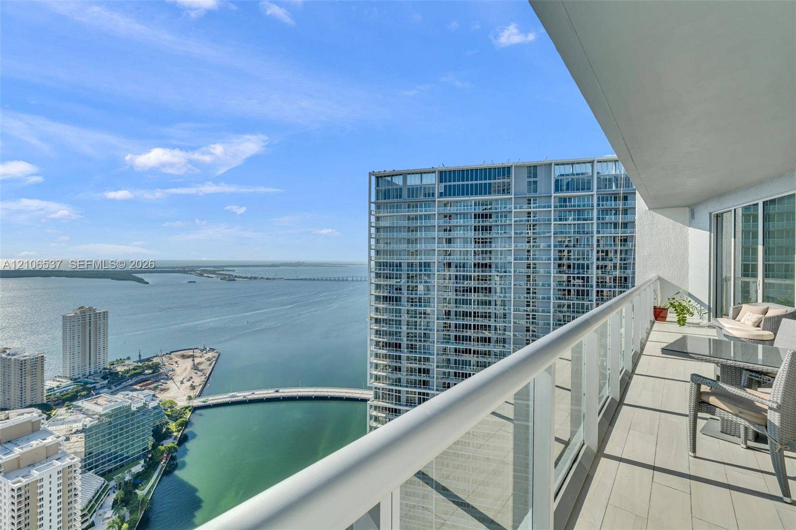 465 Brickell Avenue, #5203, Miami, FL 33131 Covered balcony with large-format tile flooring and a glass-paneled railing