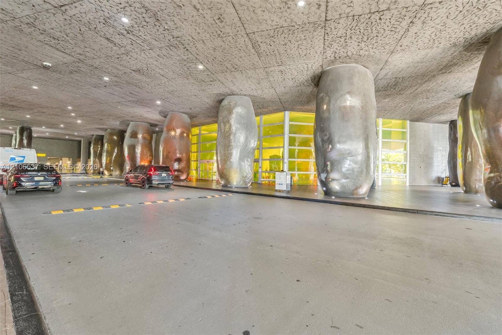 465 Brickell Avenue, #5203, Miami, FL 33131 Covered porte-cochre featuring a textured concrete ceiling, recessed lighting, and sculptural metallic columns