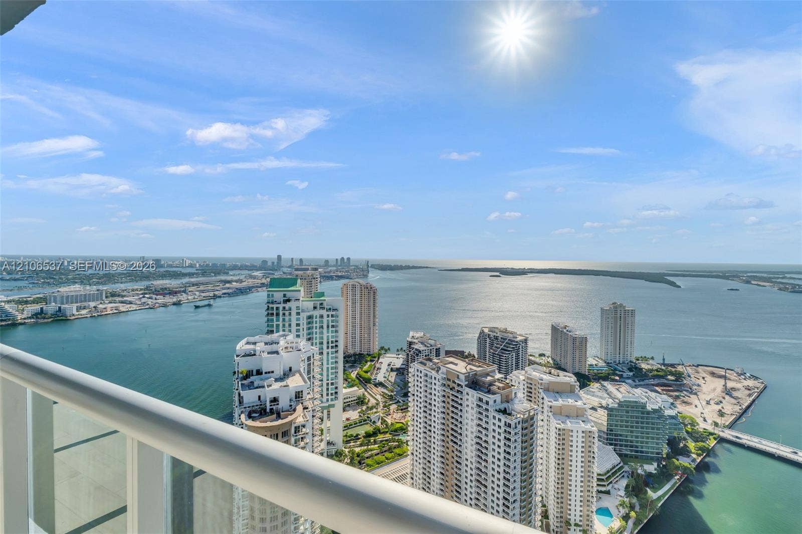 465 Brickell Avenue, #5203, Miami, FL 33131 Elevated balcony featuring a white metal railing overlooking a coastal cityscape and open water