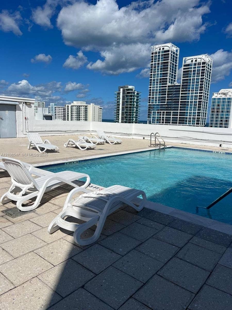 6801 Indian Creek Drive, #509, Miami Beach, FL 33141 Rooftop swimming pool featuring stone paver decking and integrated stainless steel pool ladder