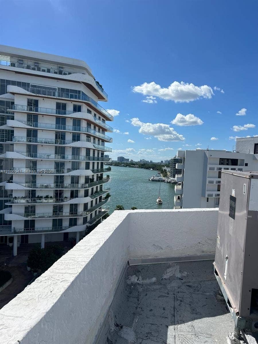 6801 Indian Creek Drive, #509, Miami Beach, FL 33141 Rooftop terrace with stucco parapet wall and prominent water scenery