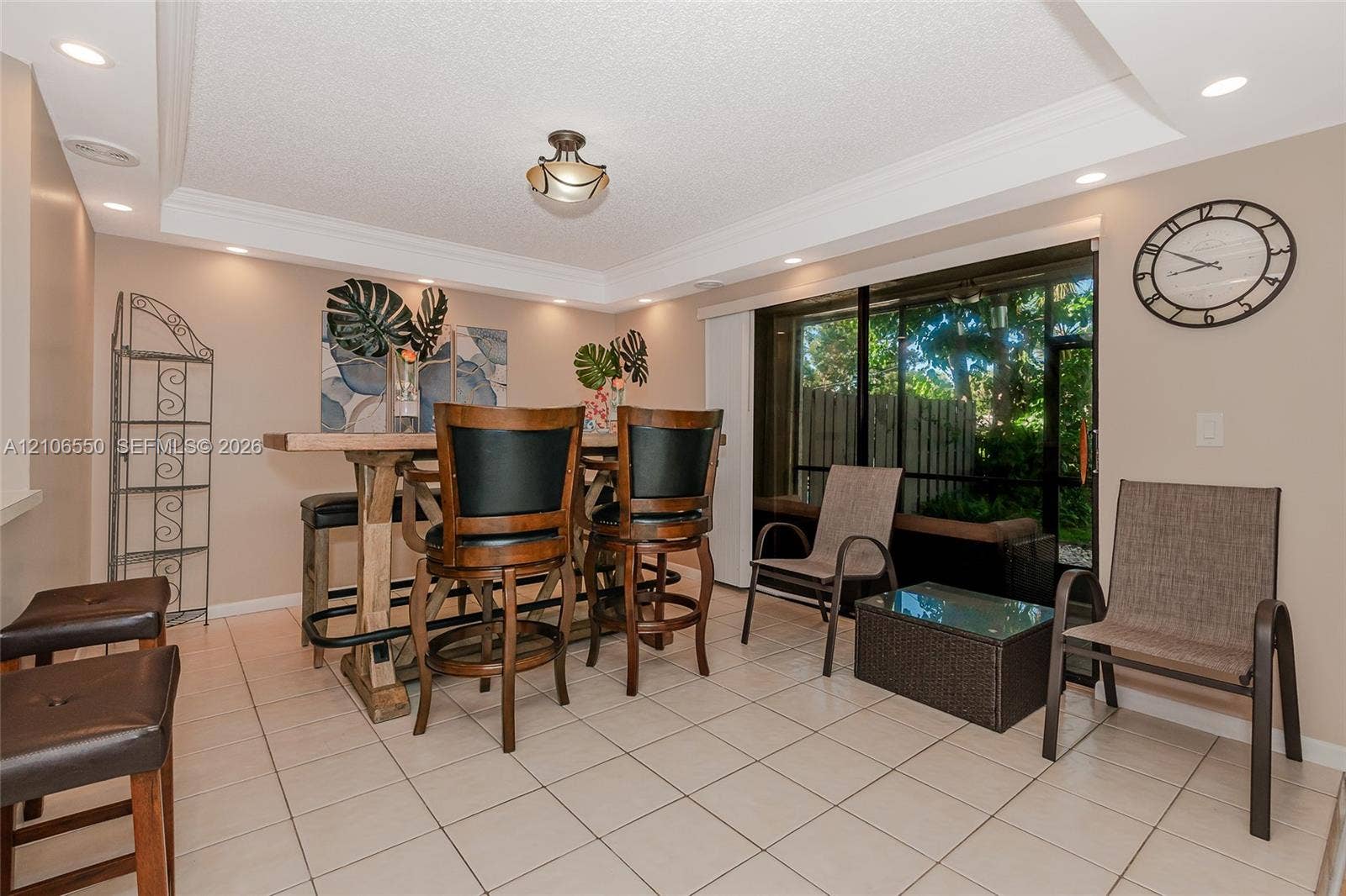 Ceramic tile flooring, crown molding, recessed lighting, and sliding glass doors