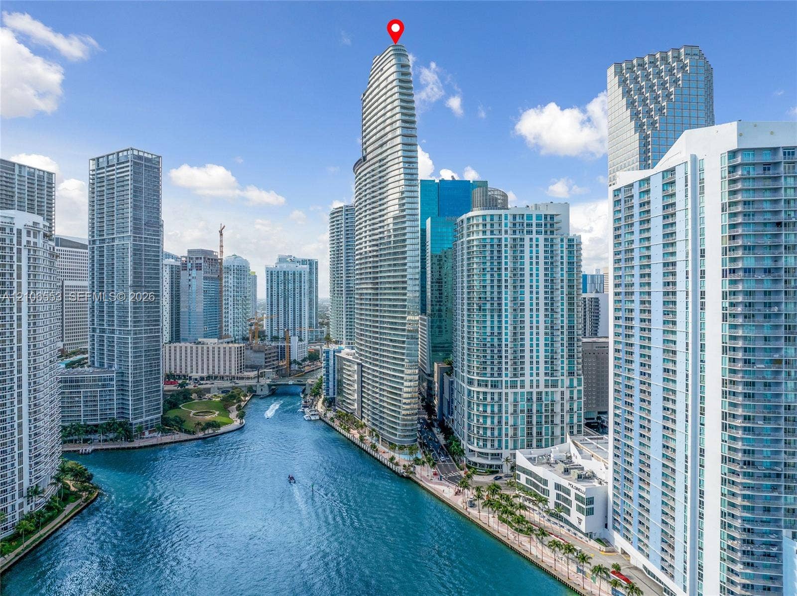 300 Biscayne Boulevard Way, #3002E, Miami, FL 33131 High-rise glass facade residential tower featuring a prominent tapered architectural design, located on a waterfront parcel with direct canal access