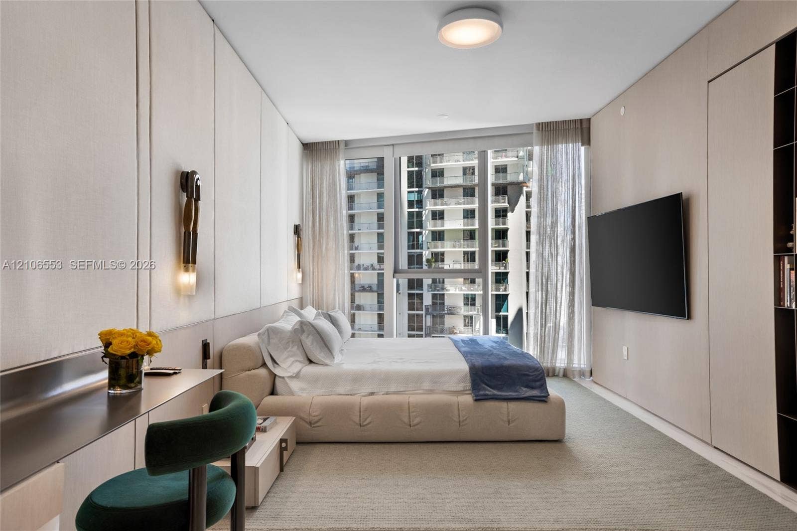 300 Biscayne Boulevard Way, #3002E, Miami, FL 33131 Floor-to-ceiling windows, custom light-toned wood paneling, wall-mounted light fixtures, flush-mount overhead lighting, and built-in shelving