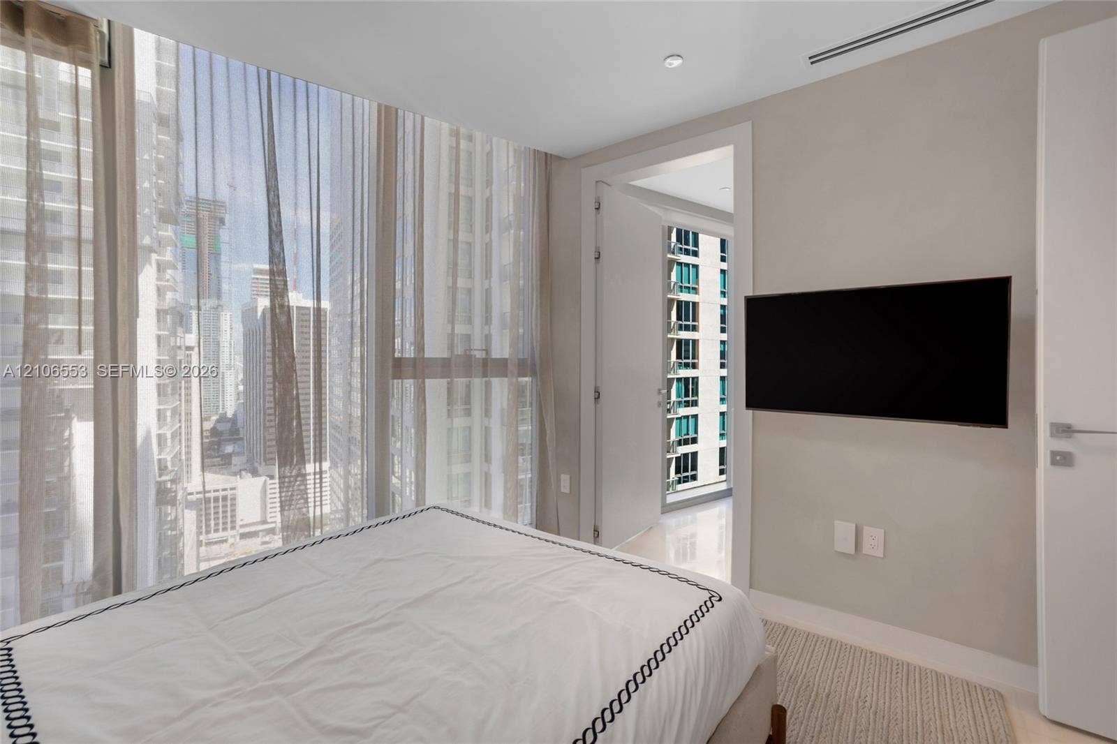 300 Biscayne Boulevard Way, #3002E, Miami, FL 33131 Floor-to-ceiling windows, polished stone flooring, recessed ceiling lighting, and wall-mounted television hardware