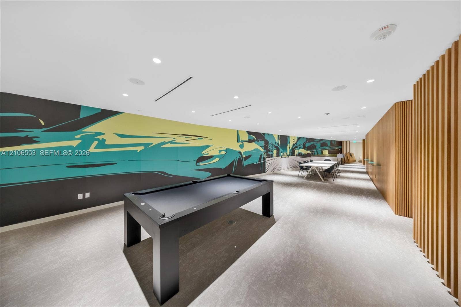 300 Biscayne Boulevard Way, #3002E, Miami, FL 33131 Large-scale graphic wall mural, recessed ceiling lighting, textured wood-slat wall paneling, and neutral flooring