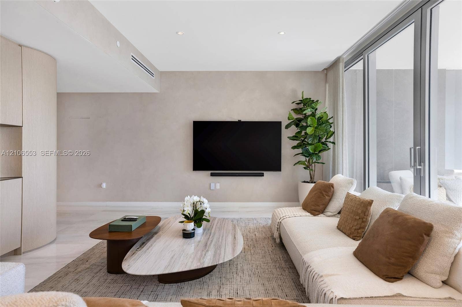 300 Biscayne Boulevard Way, #3002E, Miami, FL 33131 Floor-to-ceiling glass sliding doors, light-toned wood-finish cabinetry, neutral plaster-style walls, recessed ceiling lighting, and light-toned flooring