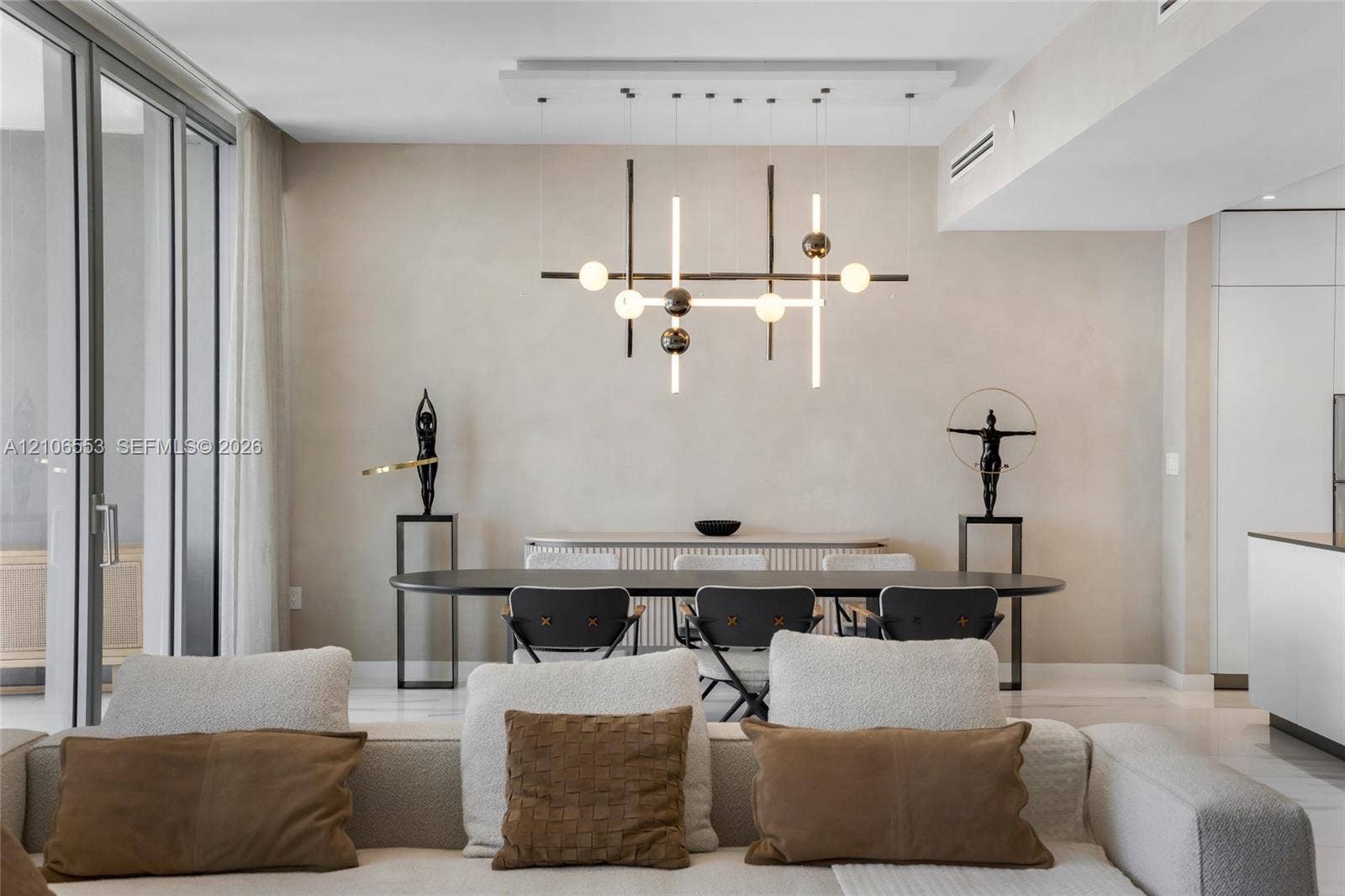 300 Biscayne Boulevard Way, #3002E, Miami, FL 33131 Modern chandelier with structural metallic frame and spherical lighting elements, floor-to-ceiling glass panel door, light-toned wall finishes, and polished flooring