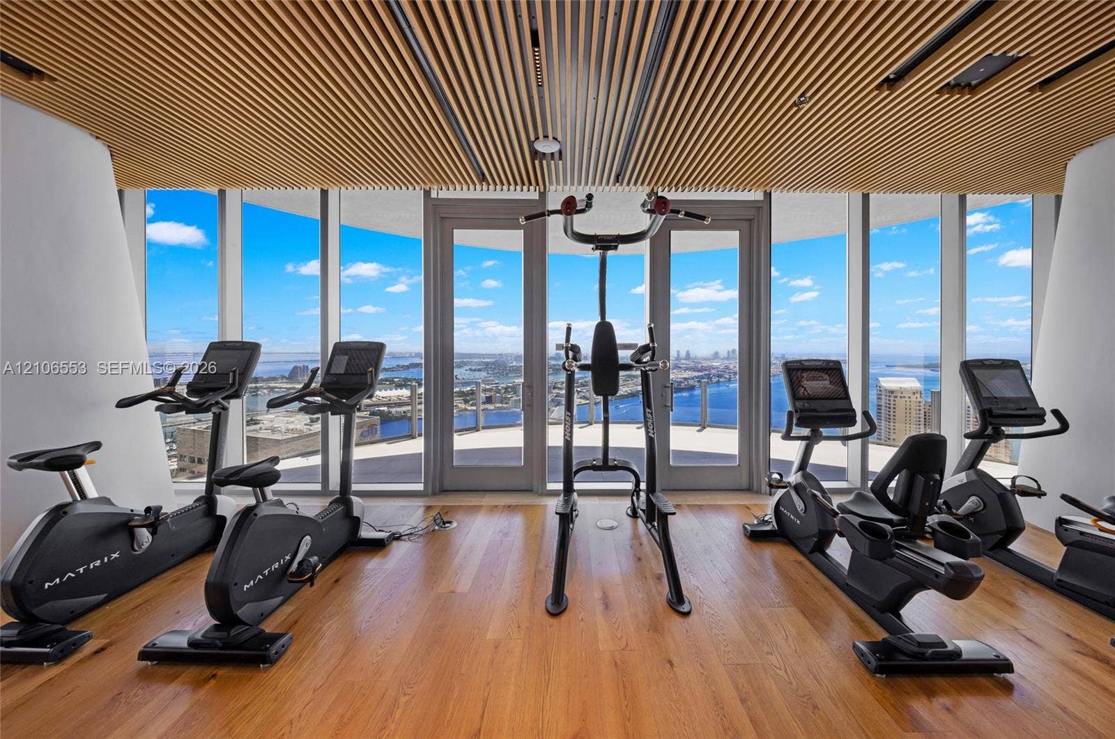 300 Biscayne Boulevard Way, #3002E, Miami, FL 33131 Floor-to-ceiling glass walls, linear wood slat ceiling, wood-finish flooring, and dual glass-paneled entry doors