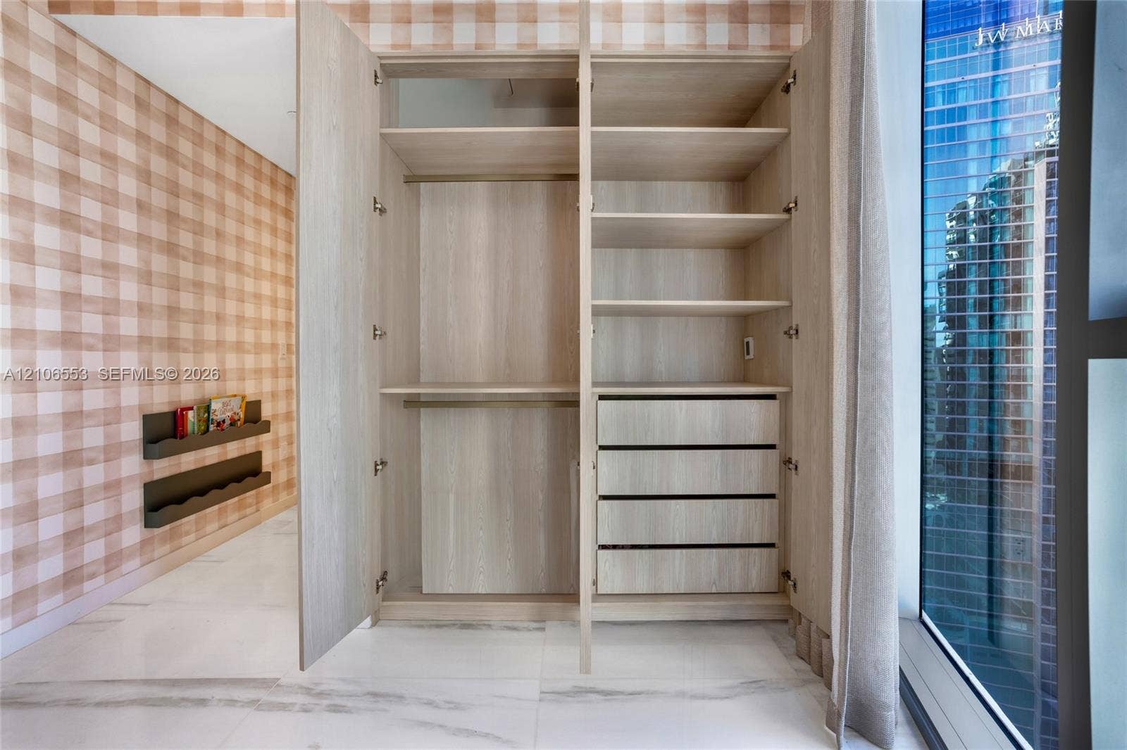 300 Biscayne Boulevard Way, #3002E, Miami, FL 33131 Built-in storage cabinet with wood-finish shelving and soft-close drawers, floor-to-ceiling windows, and large-format neutral-tone tile flooring