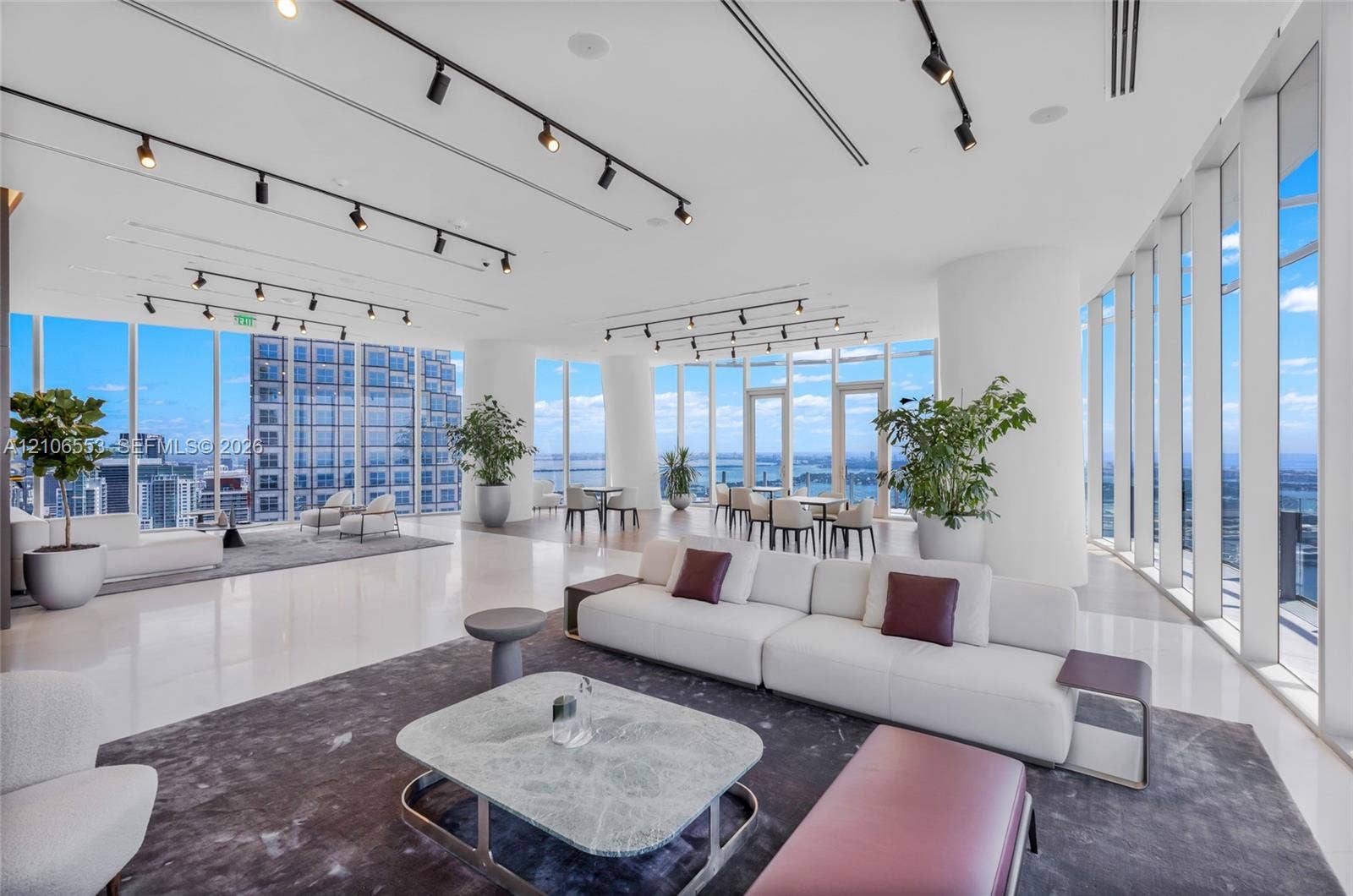 300 Biscayne Boulevard Way, #3002E, Miami, FL 33131 Expansive interior space featuring floor-to-ceiling windows, polished stone flooring, and adjustable overhead track lighting
