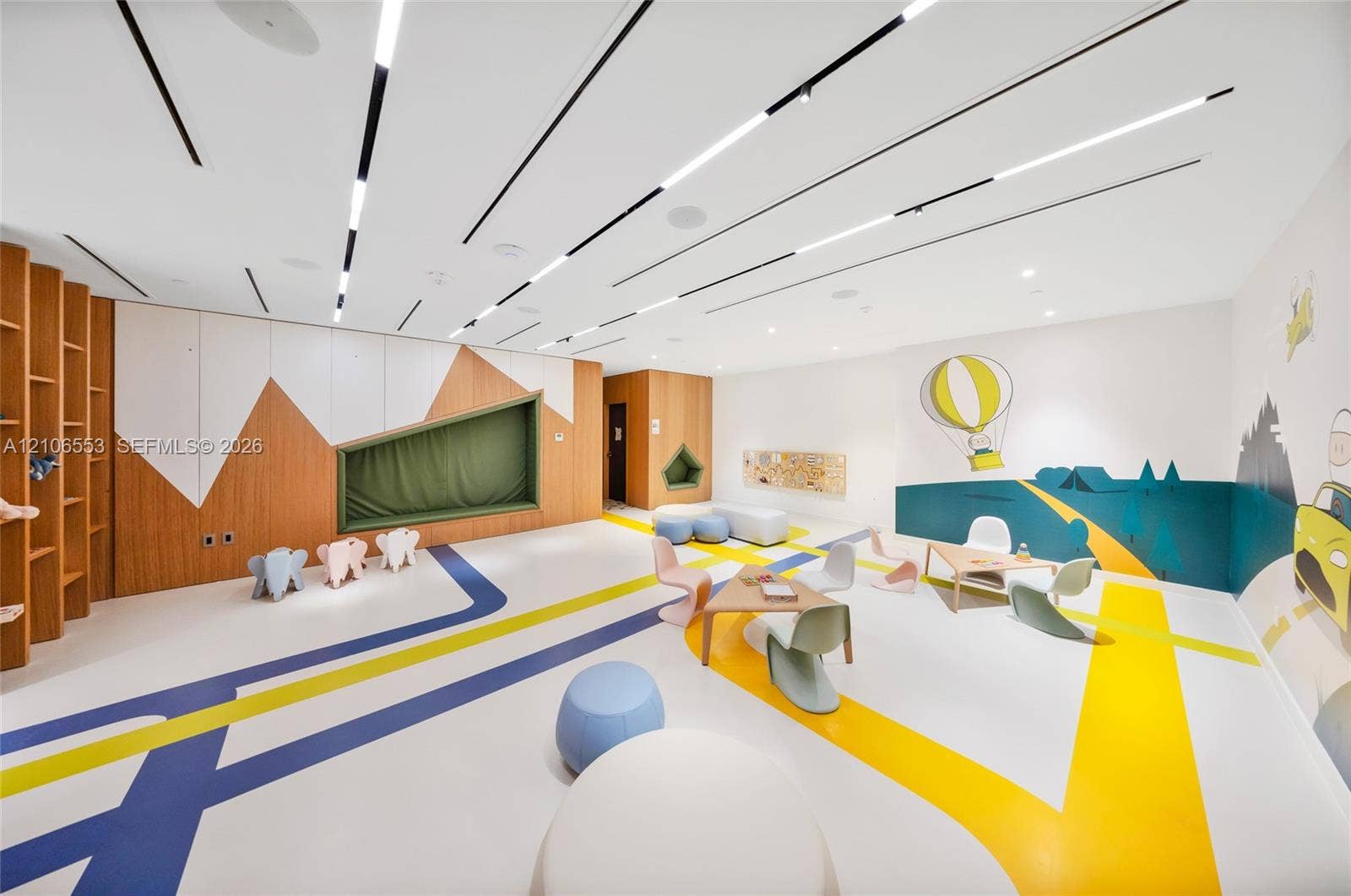300 Biscayne Boulevard Way, #3002E, Miami, FL 33131 Custom interior featuring recessed linear ceiling lighting, integrated wood-finish wall shelving, a built-in recessed wall nook, and graphic floor detailing