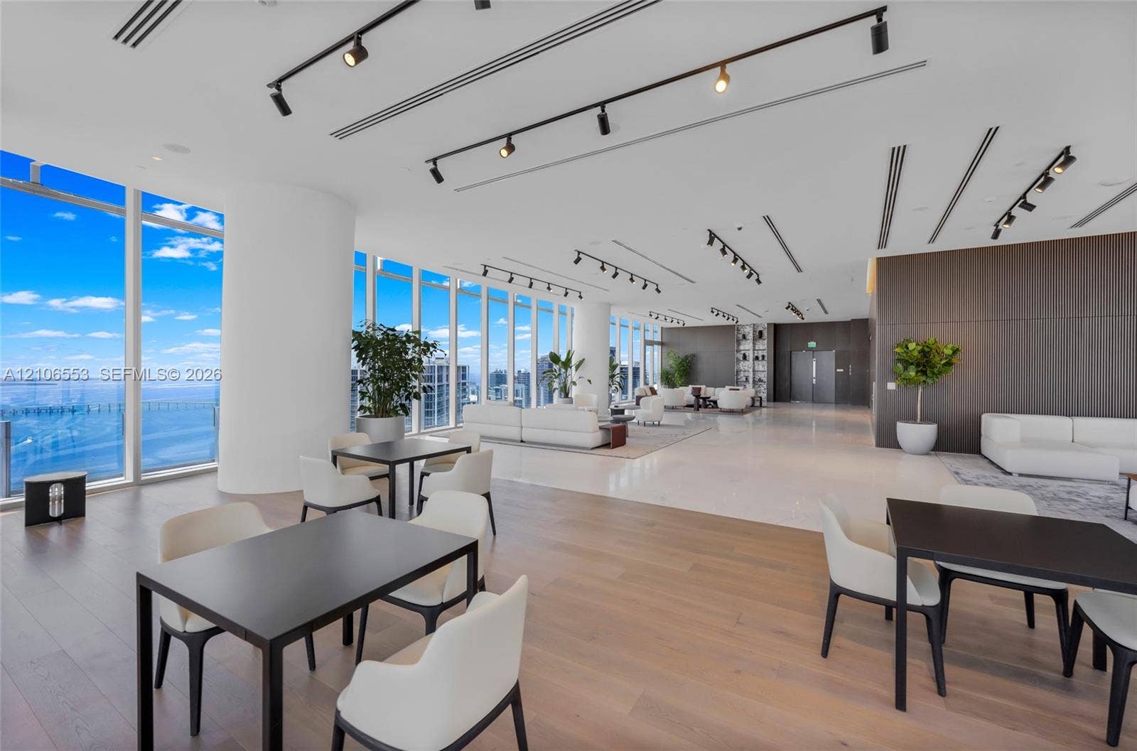 300 Biscayne Boulevard Way, #3002E, Miami, FL 33131 Open-concept space featuring floor-to-ceiling windows, wood-finish flooring, polished stone tile flooring, and integrated track lighting