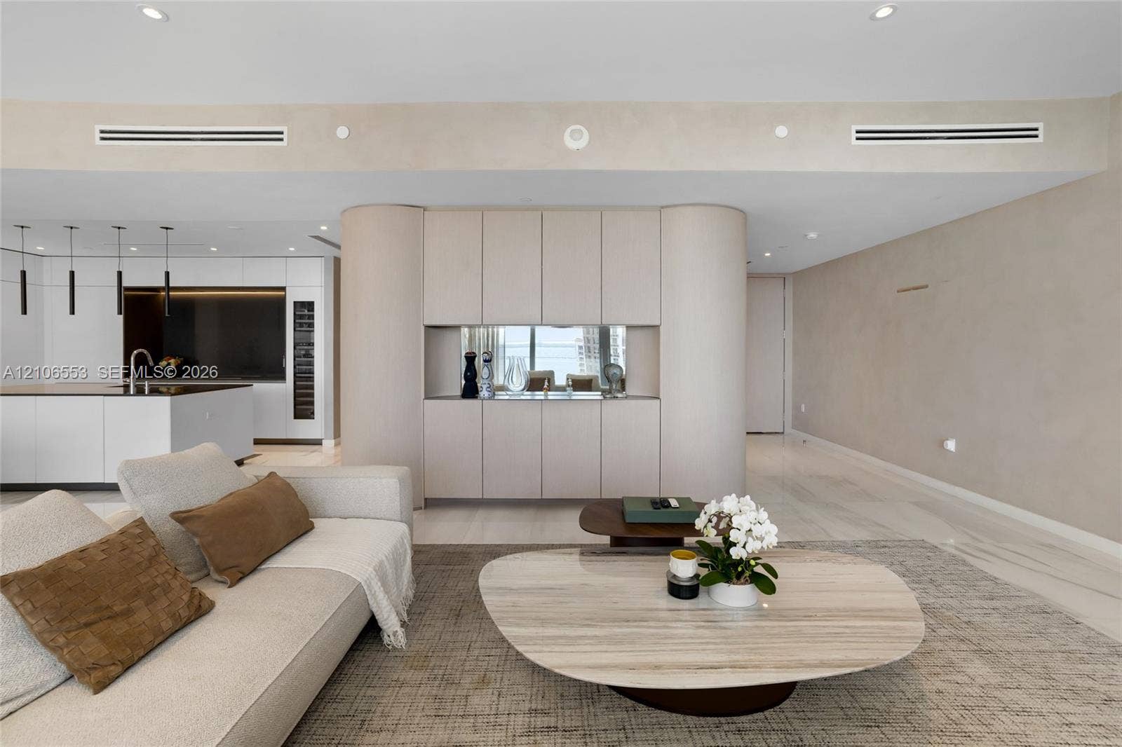 300 Biscayne Boulevard Way, #3002E, Miami, FL 33131 Custom floor-to-ceiling cabinetry with curved end-caps, integrated mirror-back shelving, recessed lighting, and stone-finish flooring