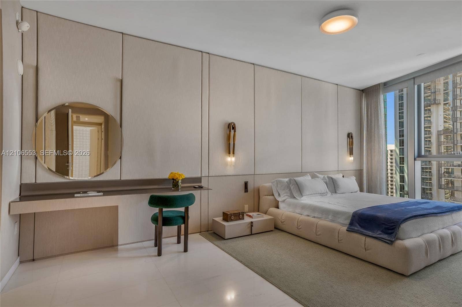 300 Biscayne Boulevard Way, #3002E, Miami, FL 33131 Custom floor-to-ceiling wall paneling, built-in floating desk, integrated circular mirror, wall-mounted light fixtures, and floor-to-ceiling windows