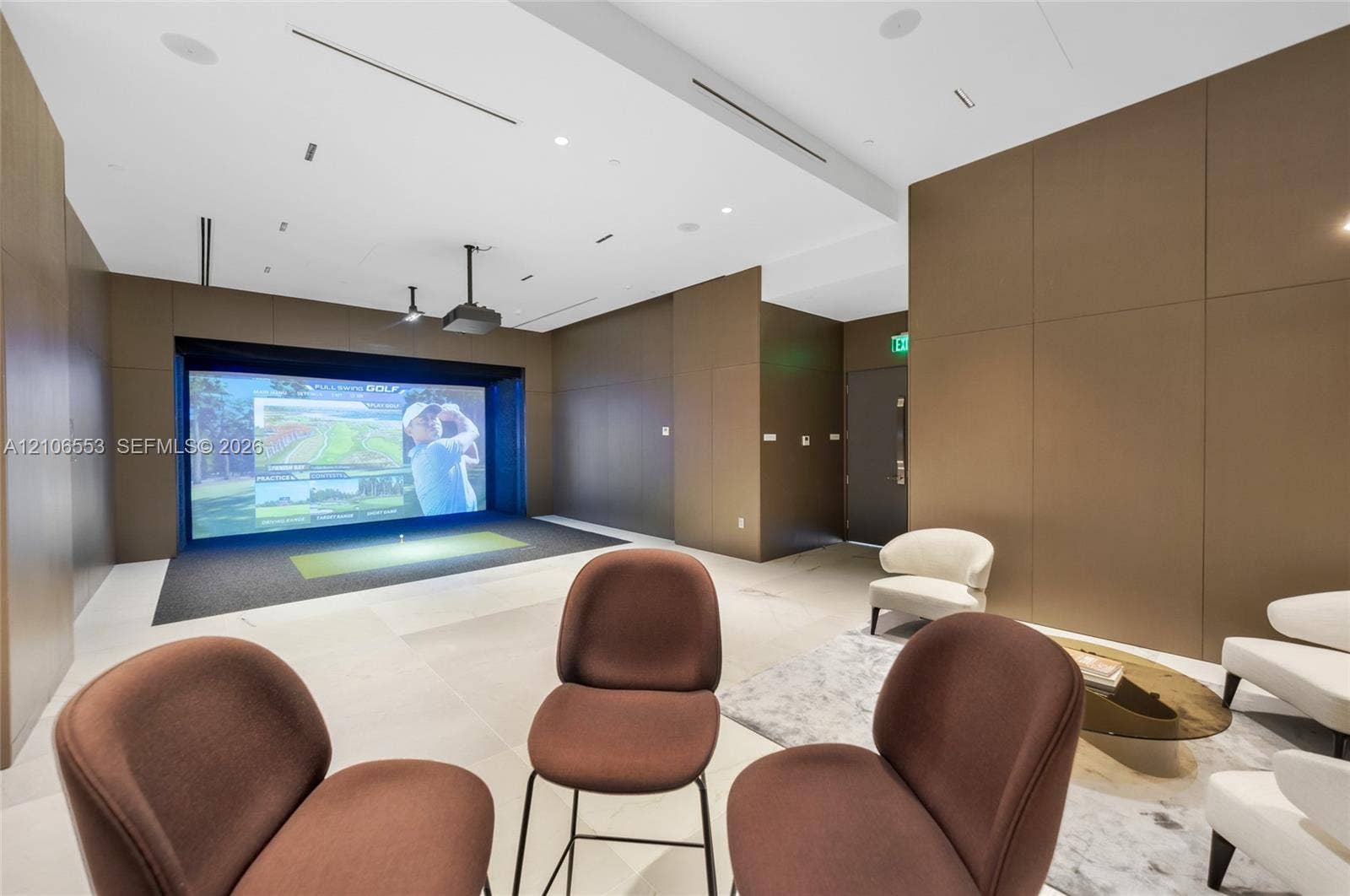 300 Biscayne Boulevard Way, #3002E, Miami, FL 33131 Golf simulator room featuring large-format tile flooring, integrated ceiling-mounted speakers, recessed linear lighting, and wood-paneled walls