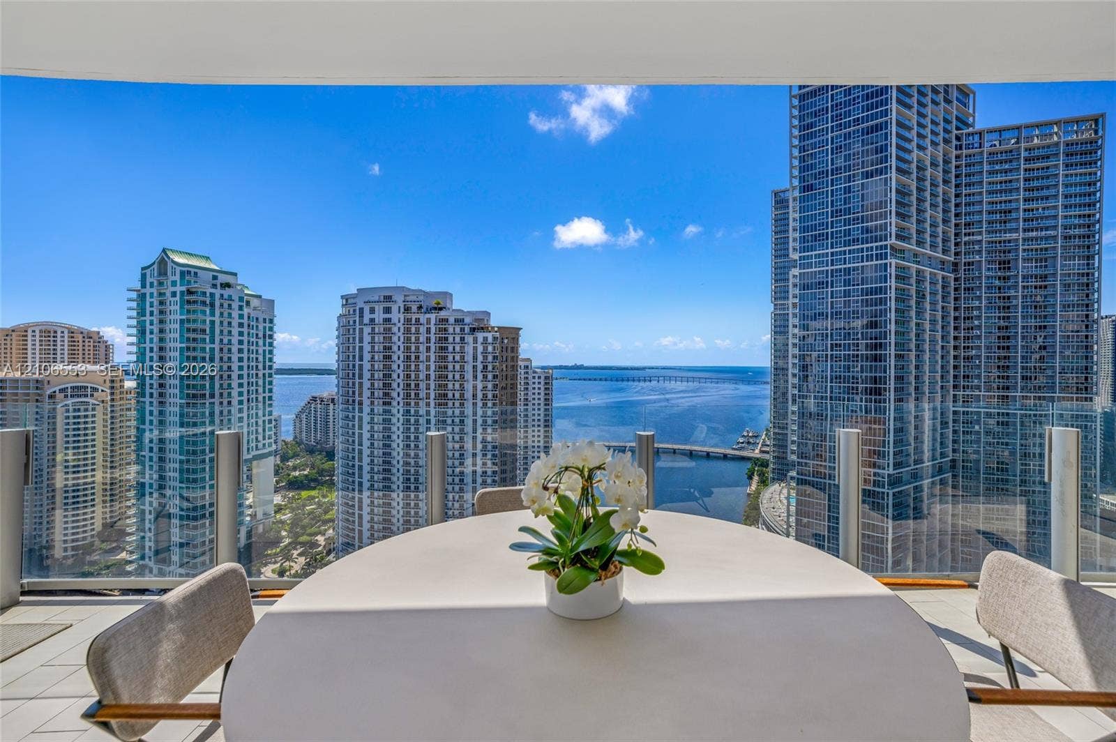 300 Biscayne Boulevard Way, #3002E, Miami, FL 33131 Covered balcony featuring glass railing panels and light-toned tile flooring