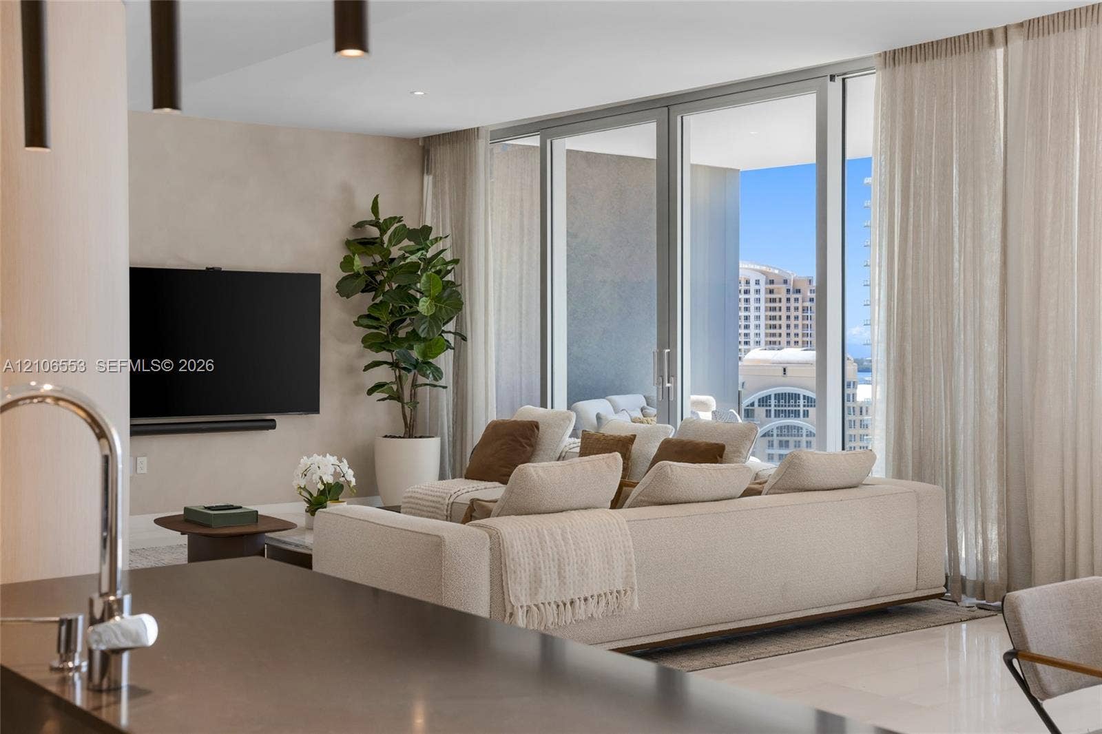 300 Biscayne Boulevard Way, #3002E, Miami, FL 33131 Floor-to-ceiling glass sliding doors, recessed lighting, matte-finish countertop with gooseneck faucet, and expansive glass pane enclosures